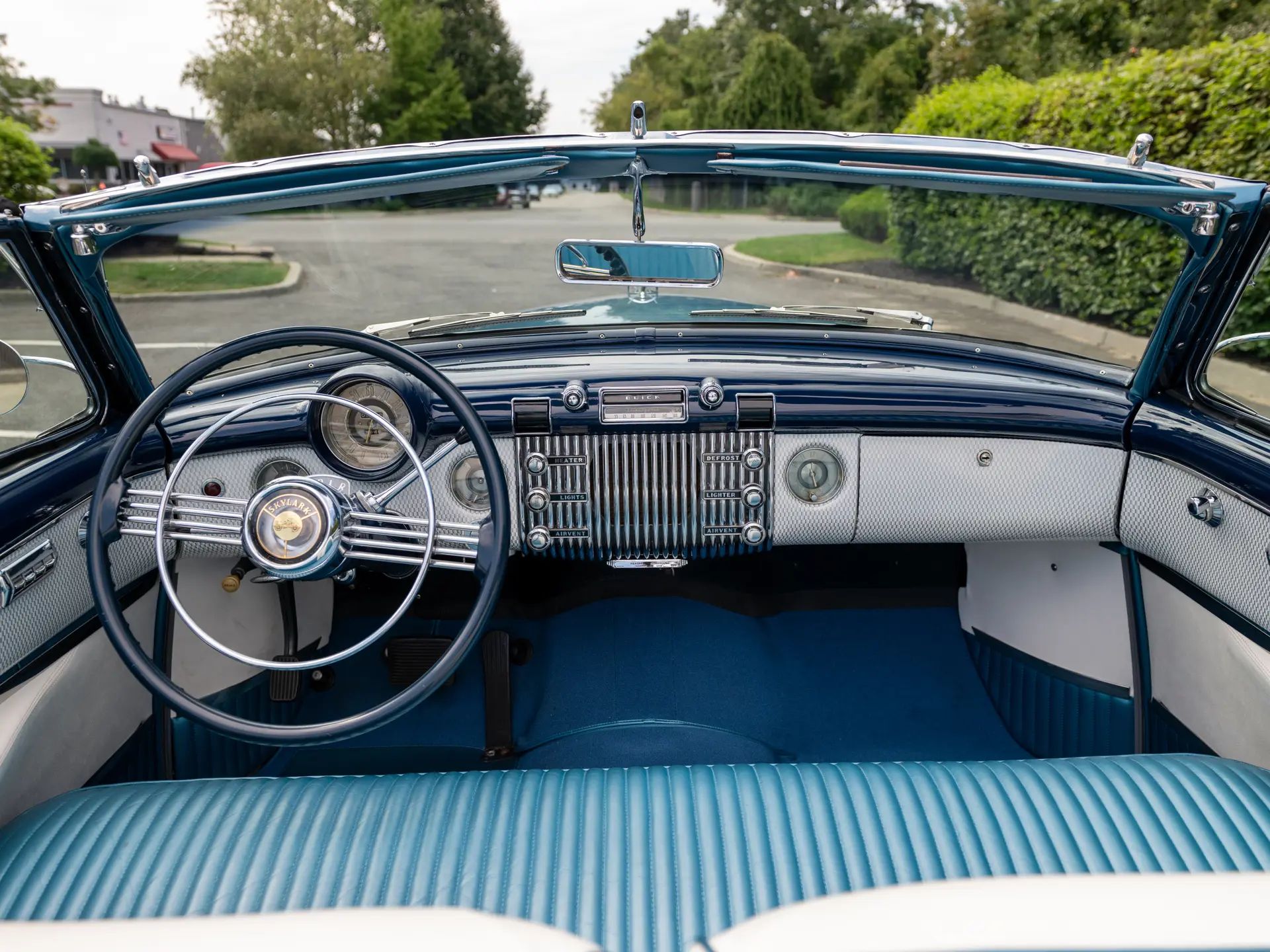 Dashboard of a 1953 Buick Skylark with the top down, seen from the back seat