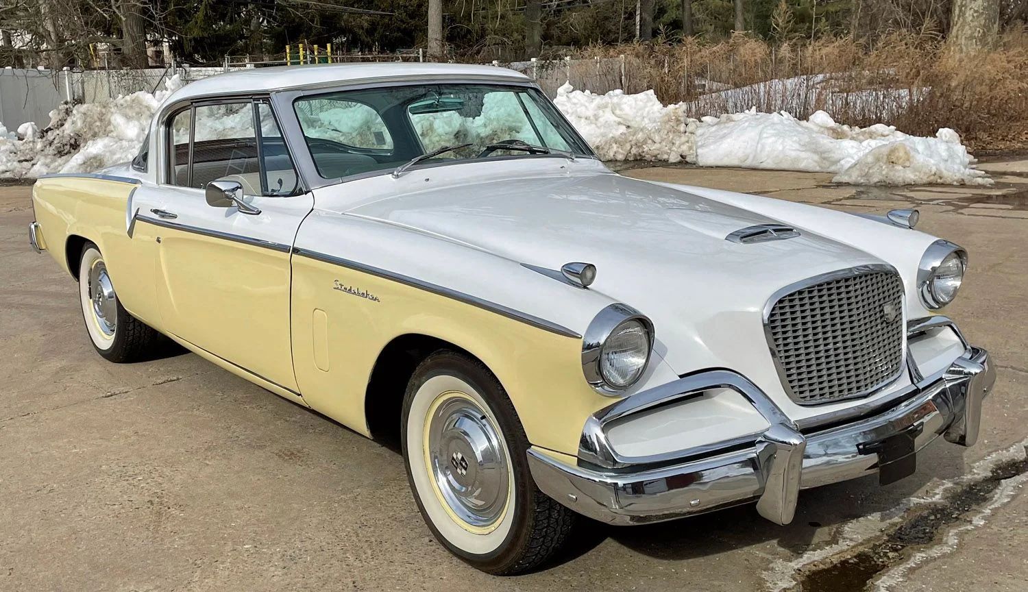 1956 Studebaker Power Hawk: It Was The Best-Selling Hawk Of 1956, But Was It The Best-Looking? 9 Passenger front 3q image of yellow-and-white 1956 Studebaker Sky Hawk in a parking lot with plowed snow
