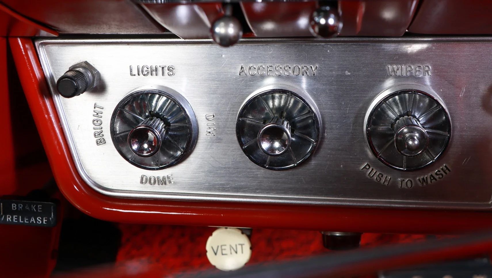 Headlight and wiper switches on the left side of the dash of a 1960 Buick