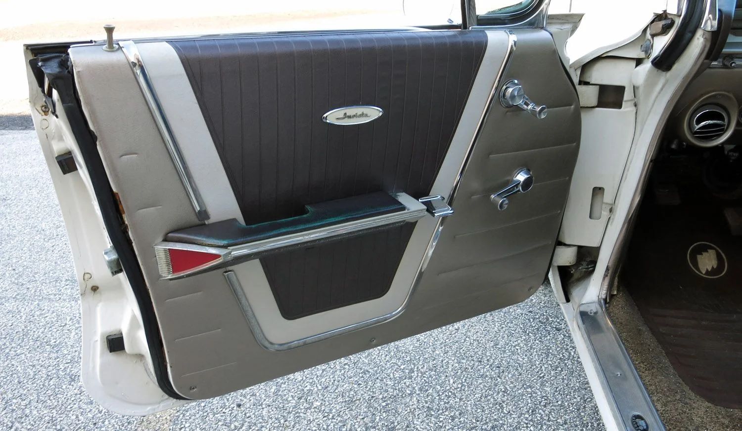 Driver's door trim of a 1961 Buick with wind-up windows