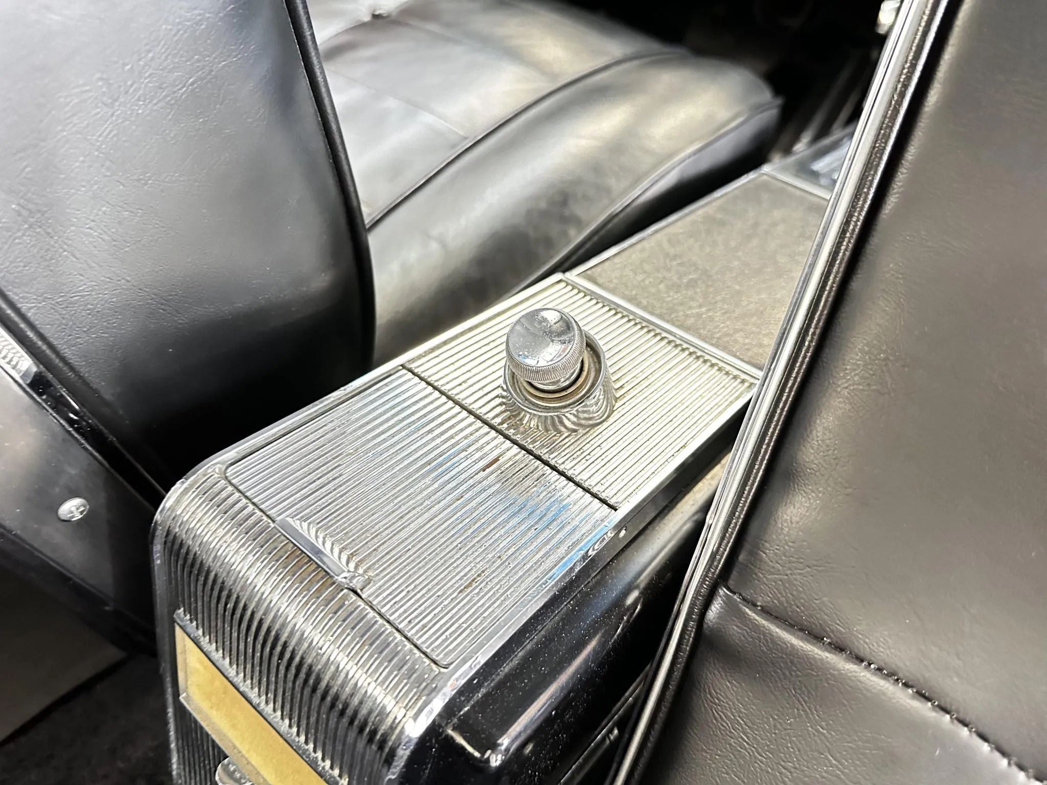 Ashtray and cigarette lighter in the back of a 1963 Riviera center console