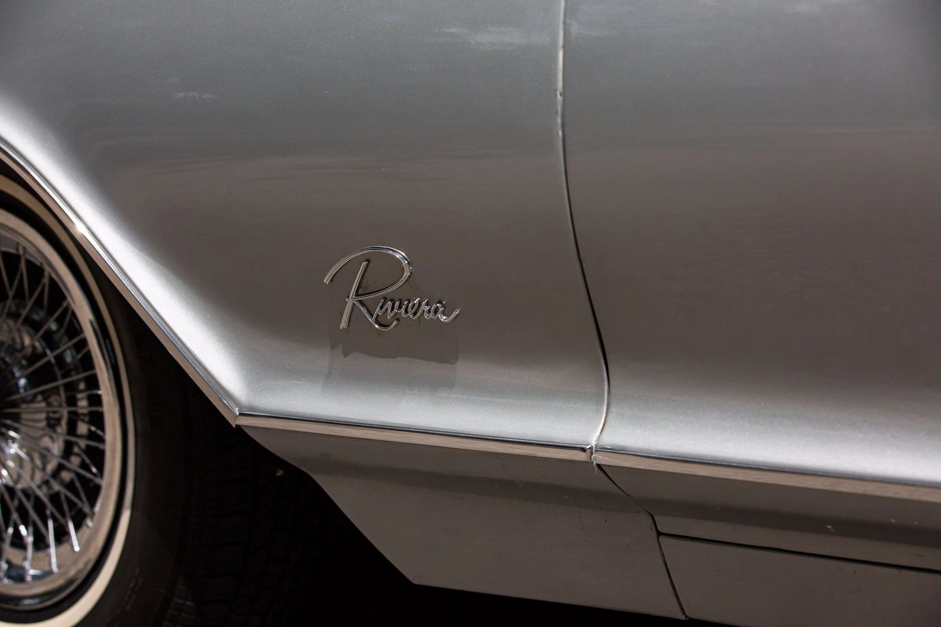 Riviera script on the left front fender of a silver car
