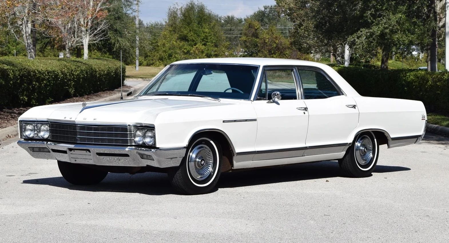 Left front 3q view of a 1966 Buick four-door sedan parked diagonally in the middle of a street