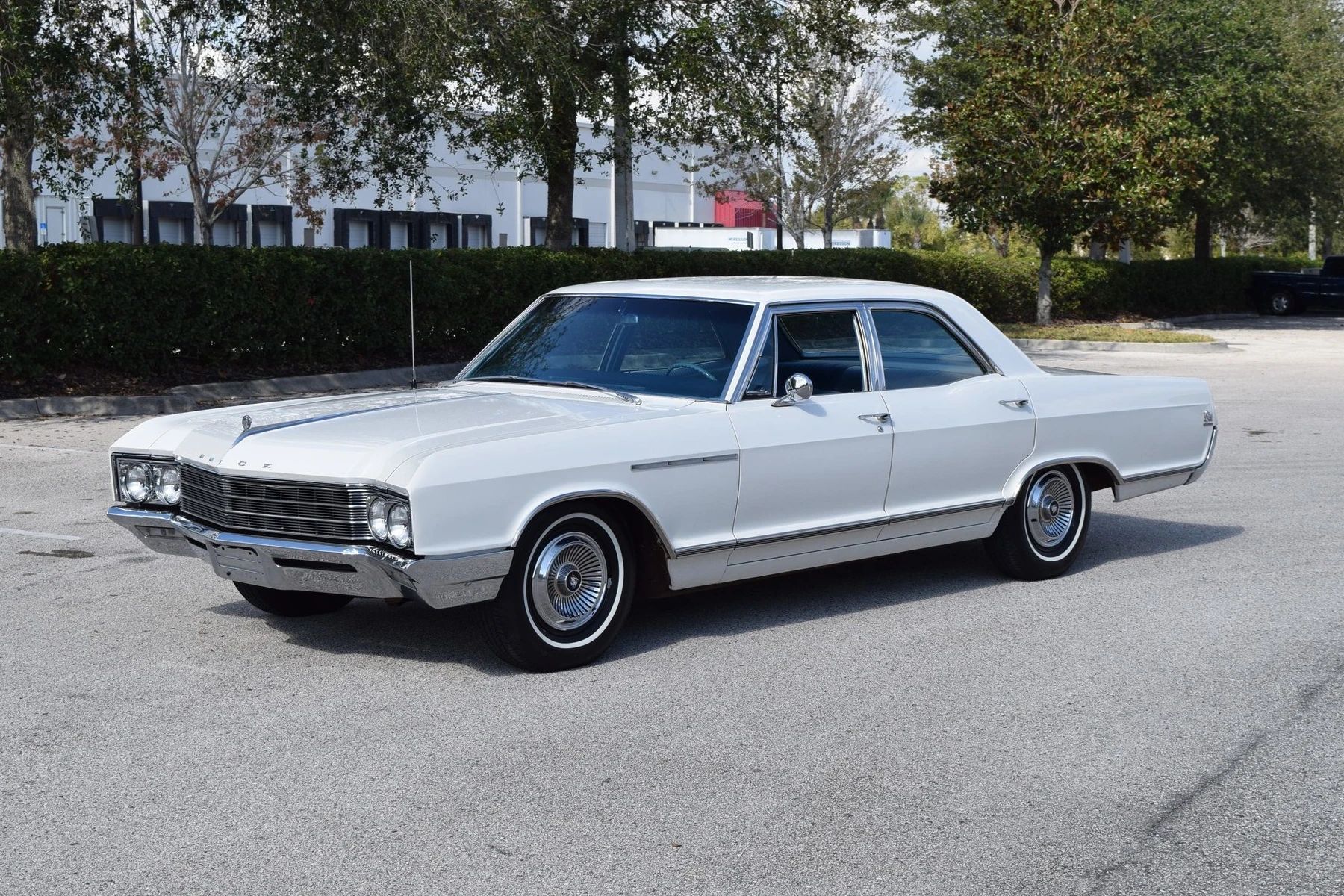 Left front 3q view of an Arctic White 1966 Buick LeSabre four-door sedan
