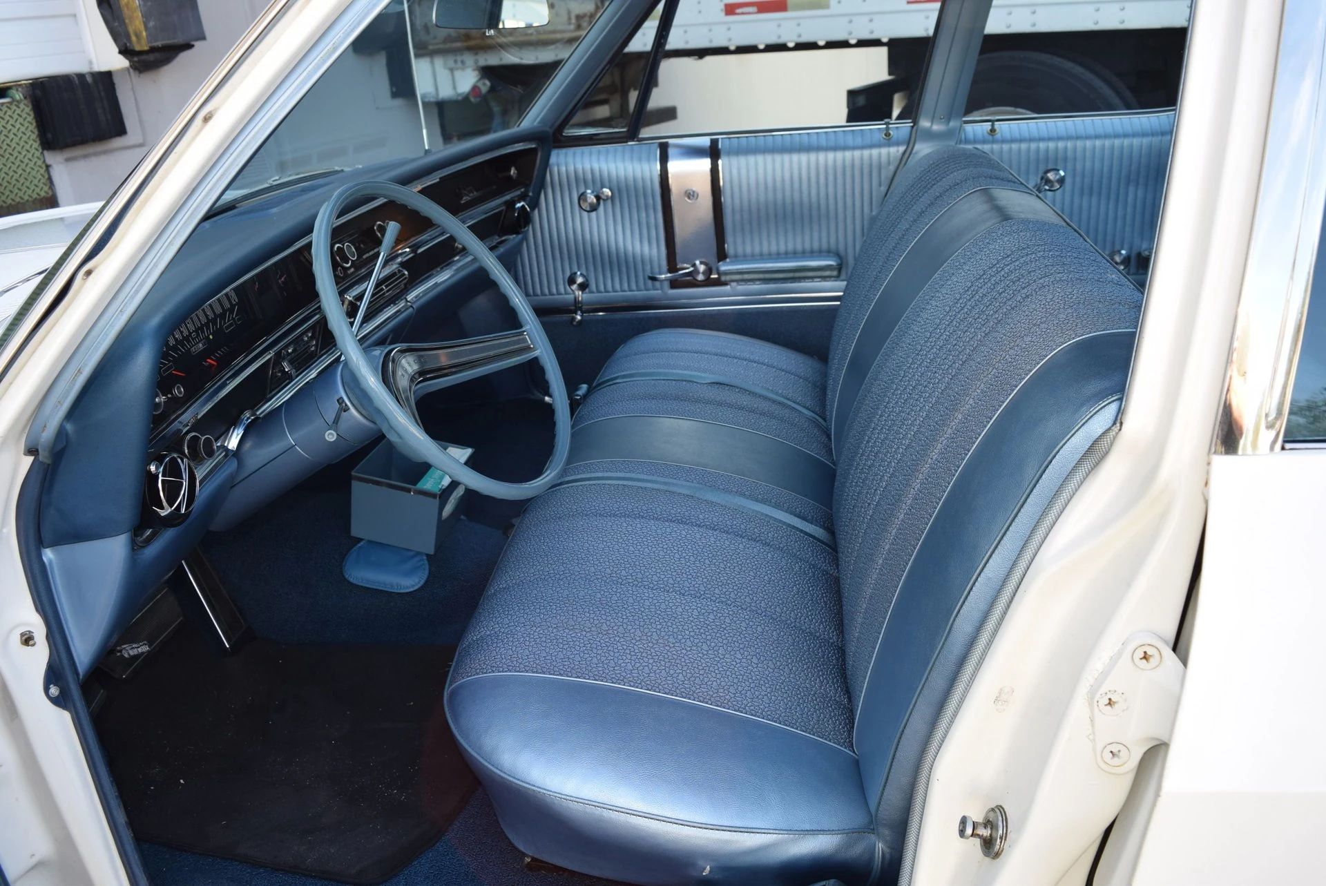 Front bench seat of a 1966 Buick four-door sedan, seen through the driver's door