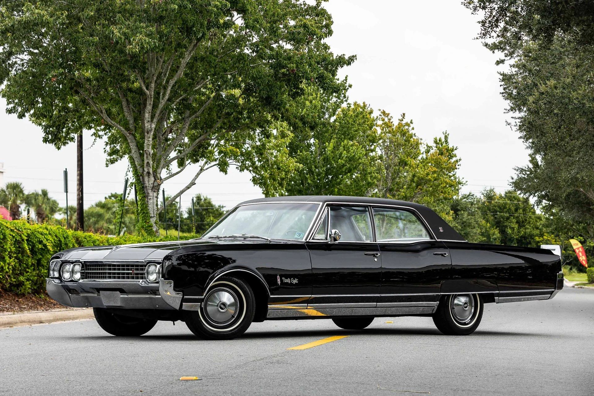 1966 Oldsmobile Ninety-Eight Town Sedan: GM's Cheapest C-Body Luxury Car 5 Left front 3q view of a 1966 Oldsmobile 98 four-door sedan parked diagonally in the middle of a street