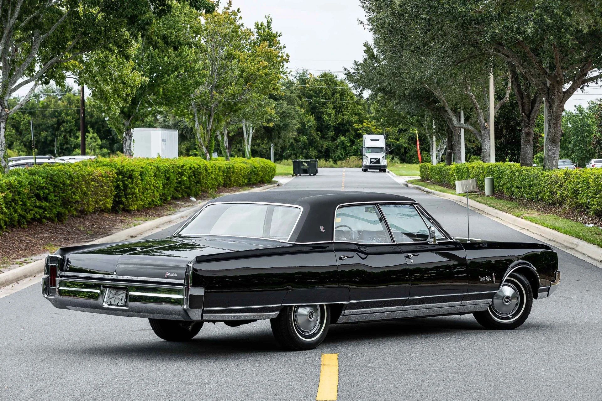1966 Oldsmobile Ninety-Eight Town Sedan: GM's Cheapest C-Body Luxury Car 15 Right rear 3q view of a 1966 Oldsmobile four-door sedan parked diagonally in the middle of a street