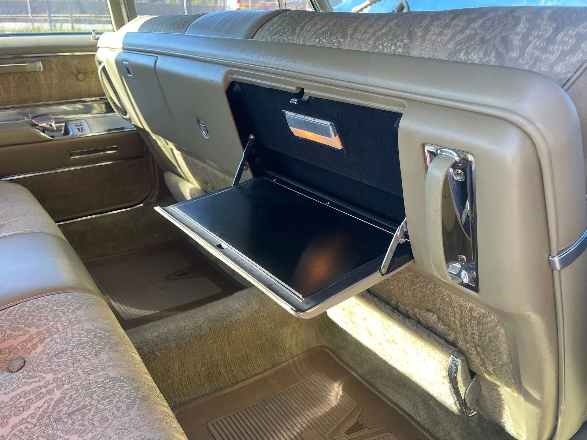 Back seat and folding tray in a 1967 Cadillac four-door sedan, seen from the right