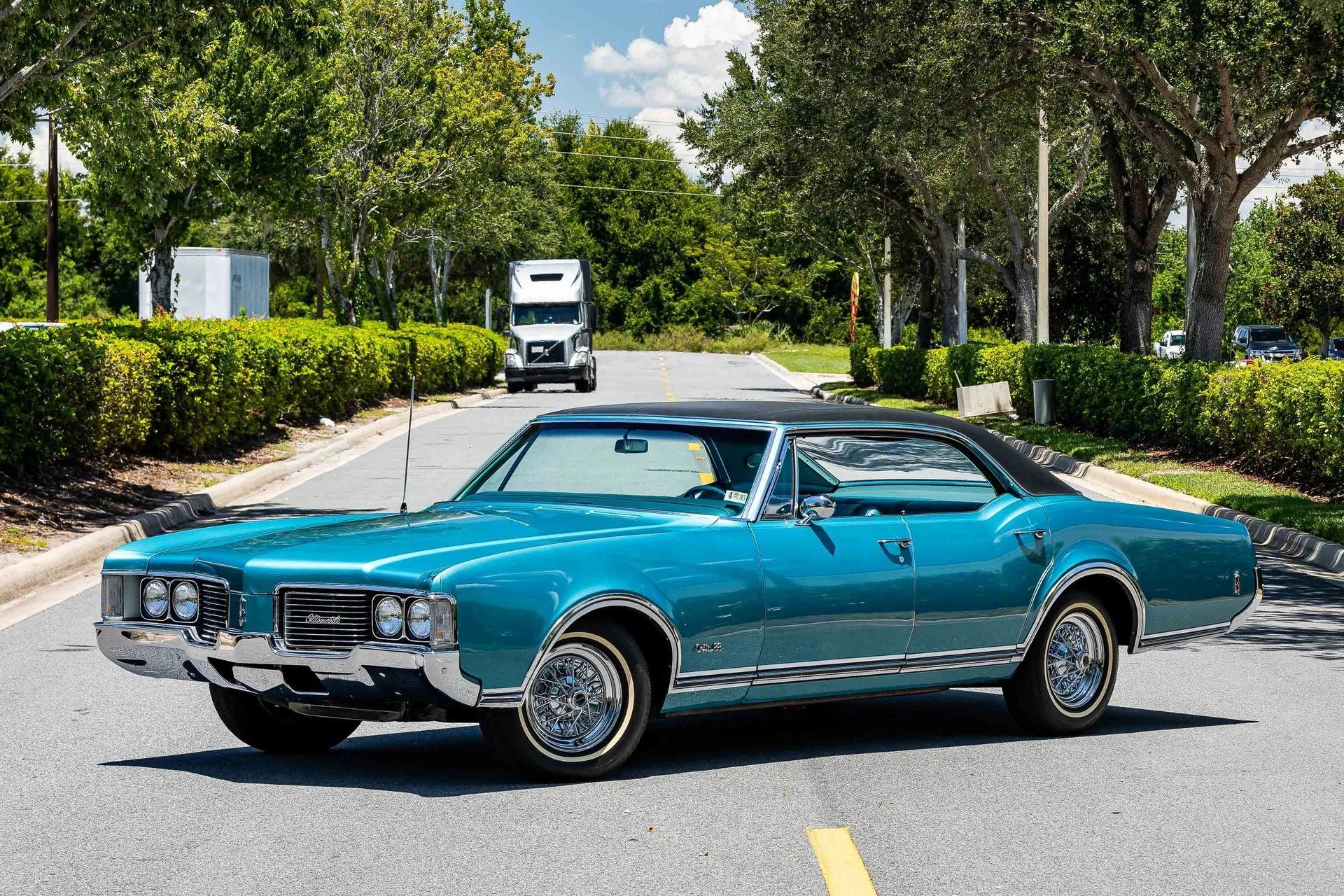 1968 Oldsmobile Delta 88 Holiday Sedan: A Cool Blue Olds "Youngmobile" In Ocean Turquoise 1 Left front 3q view of an Ocean Turquoise 1968 Oldsmobile Delta 88 four-door hardtop parked diagonally in the middle of a street