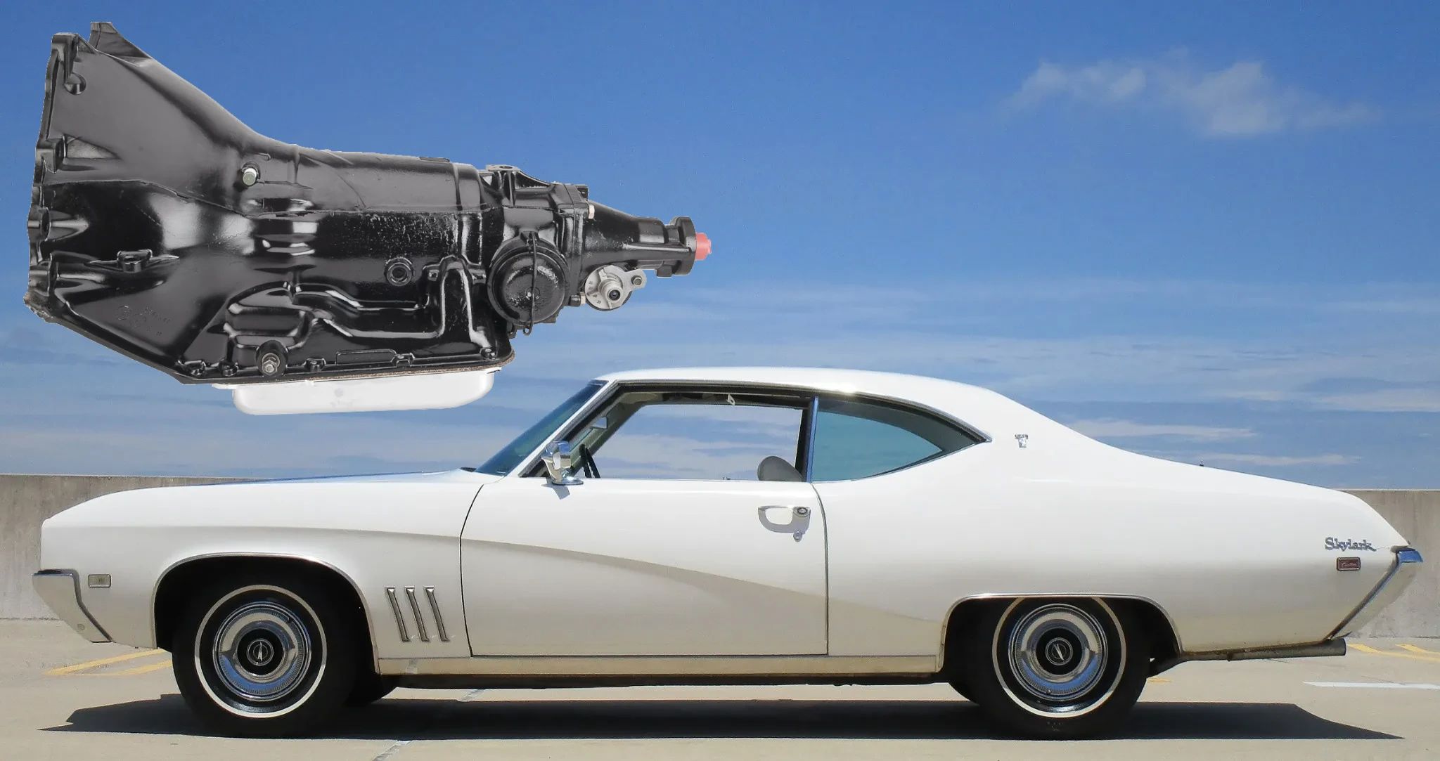 Left side view of a white 1969 Buick Skylark Custom two-door hardtop with an image of a TH350 transmission floating above it