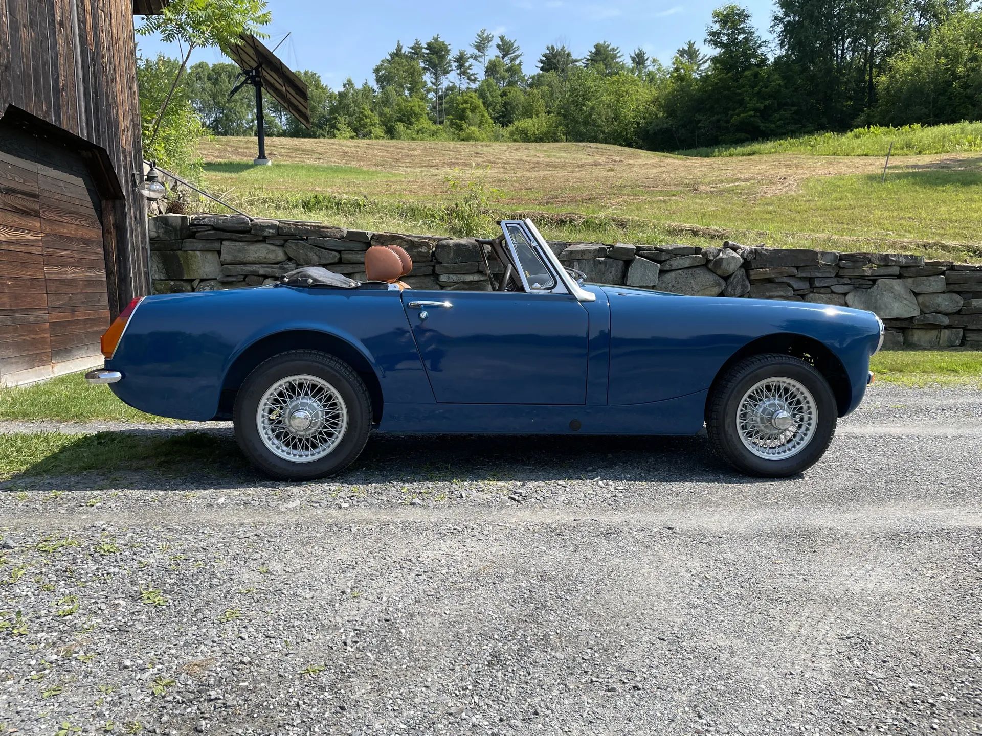 Passenger side view of blue 1973 MG Midget