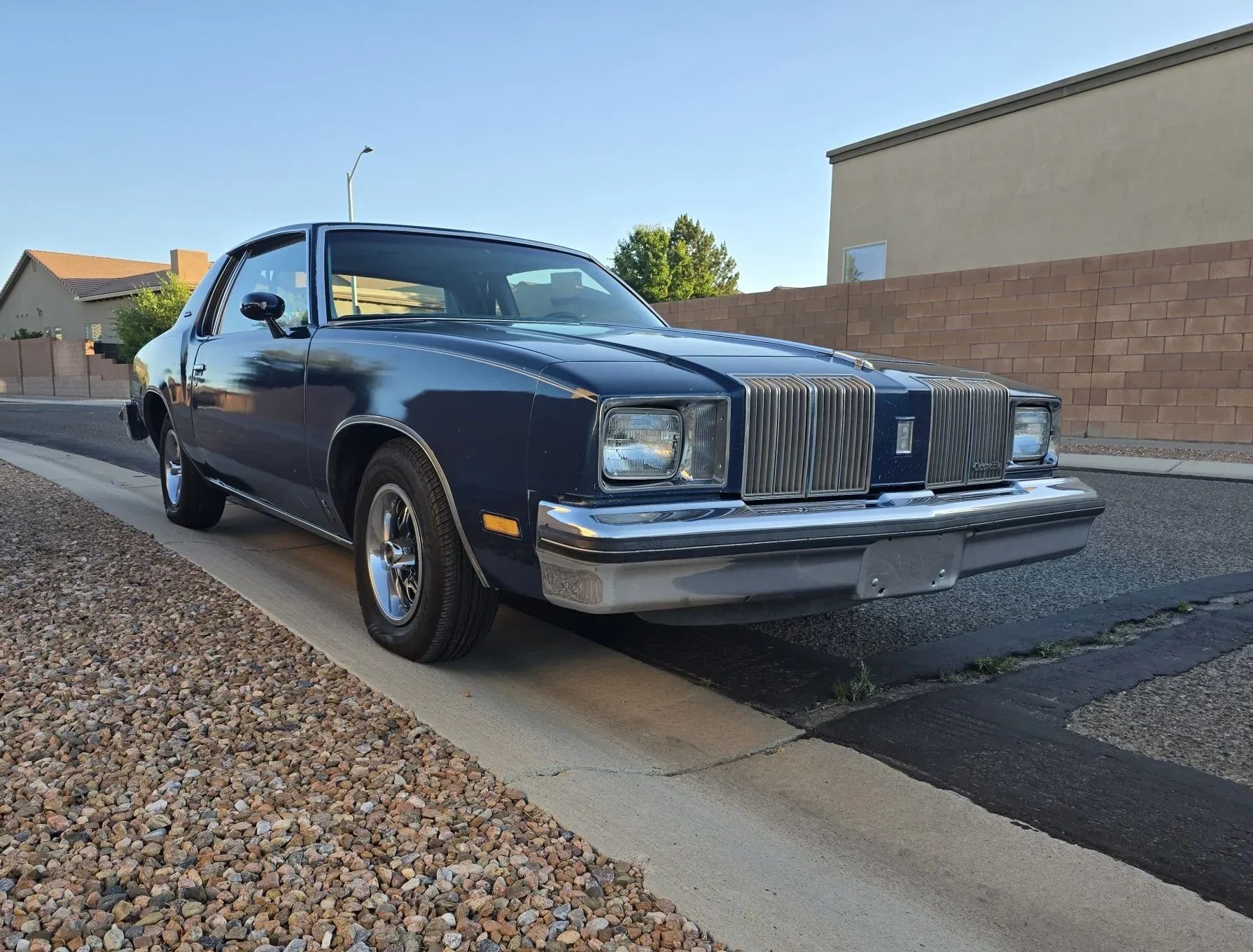 Passenger front 3q image of dark blue 1979 Oldsmobile Cutlass Supreme