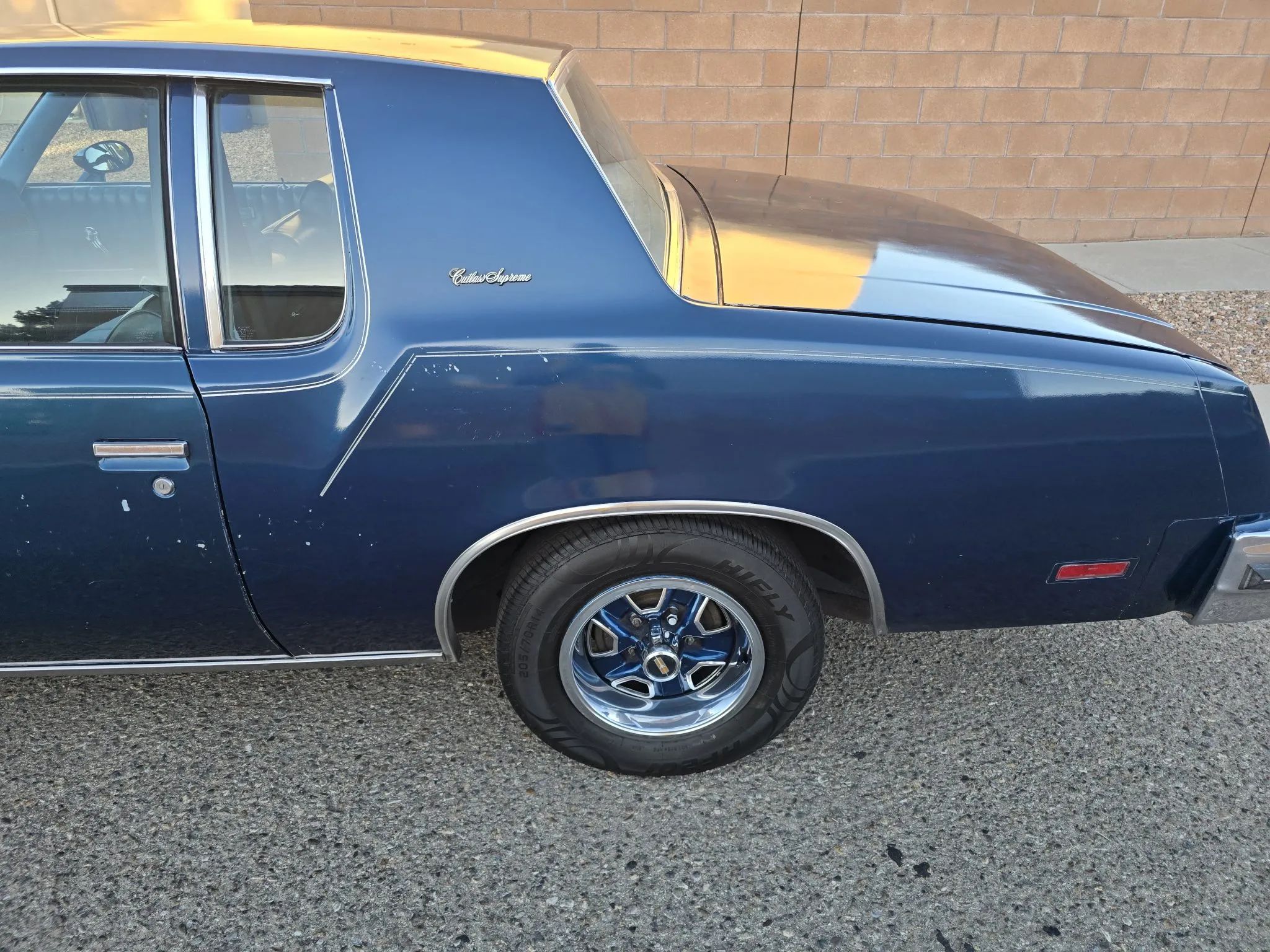 Closeup of driver quarter panel of dark blue 1979 Oldsmobile Cutlass Supreme
