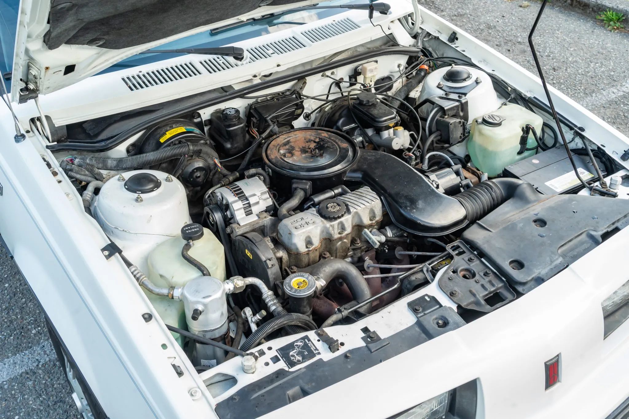 1987 Oldsmobile Firenza Cruiser Wagon: A Rare, Rust-Free Example Of A Wagon You've Probably Forgotten About 3 Engine compartment of white 1987 Oldsmobile Firenza Wagon with 2.0-liter OHC four