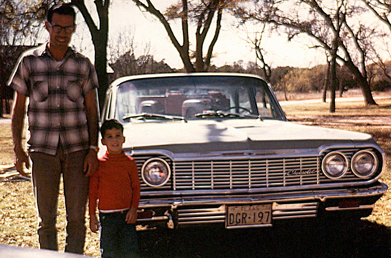 Father an son in front of a 1964 Chevrolet Impala circa 1970.
