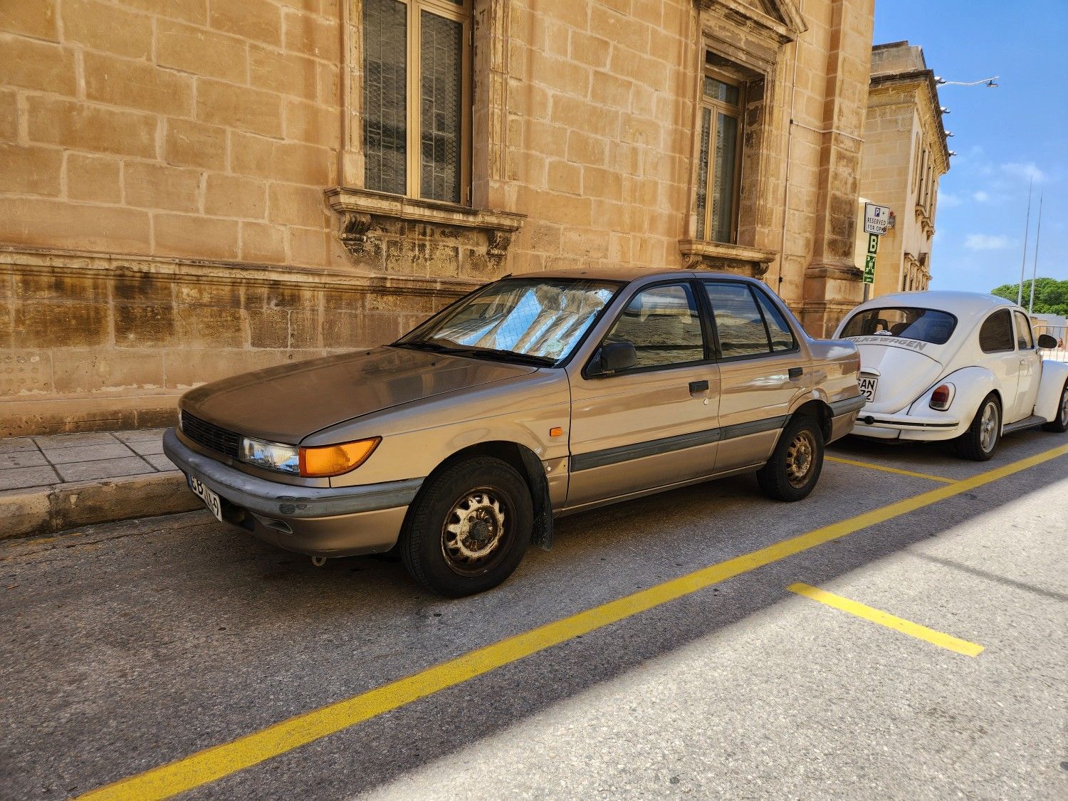 Classic Cars of Malta: Automotive Melting Pot - Ford, Morris, Suzuki, Skoda, etc 23 Mitsubishi Lancer near the Beetle.
