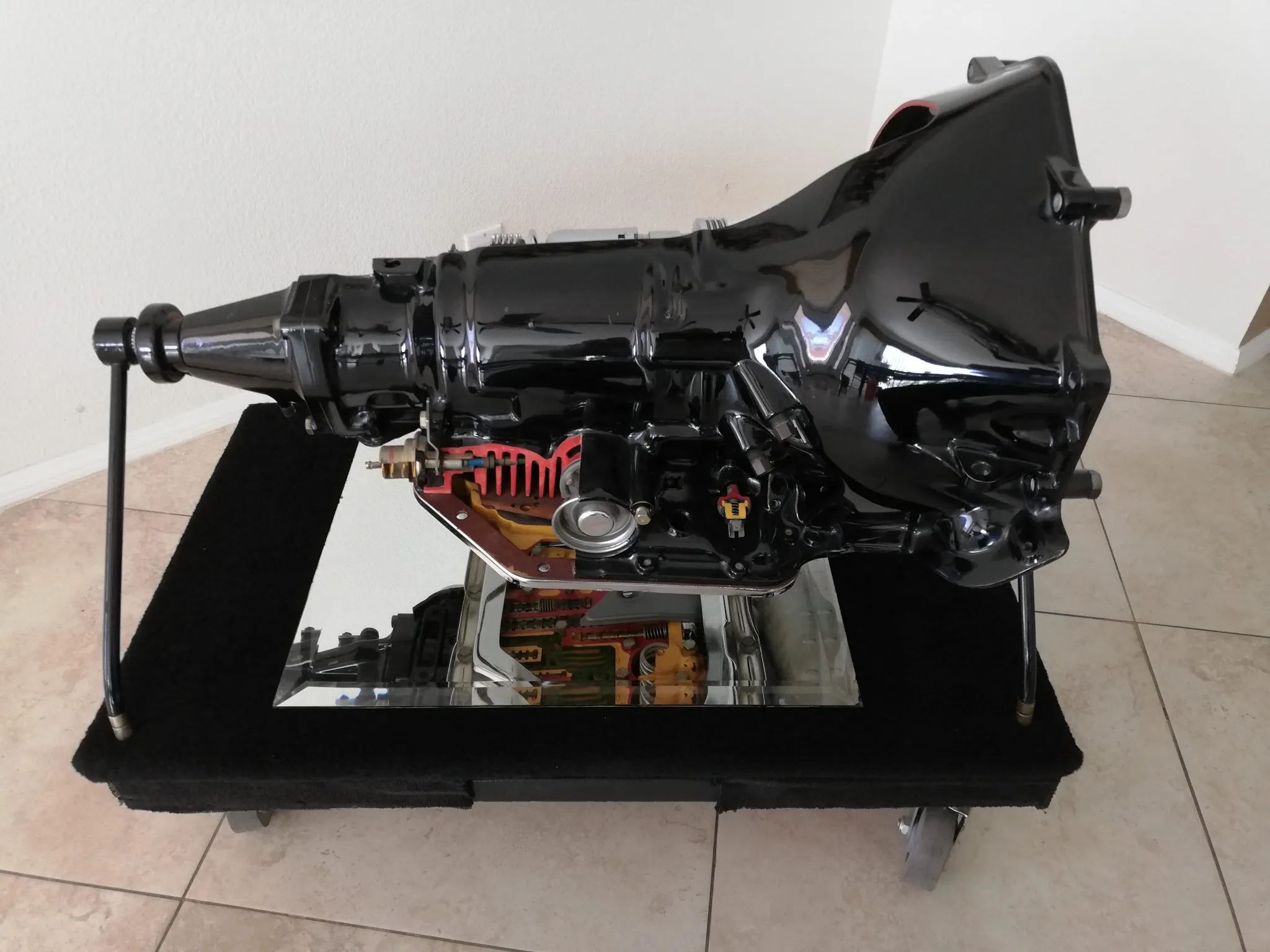 Non-cutaway side of an automatic transmission model on a display stand