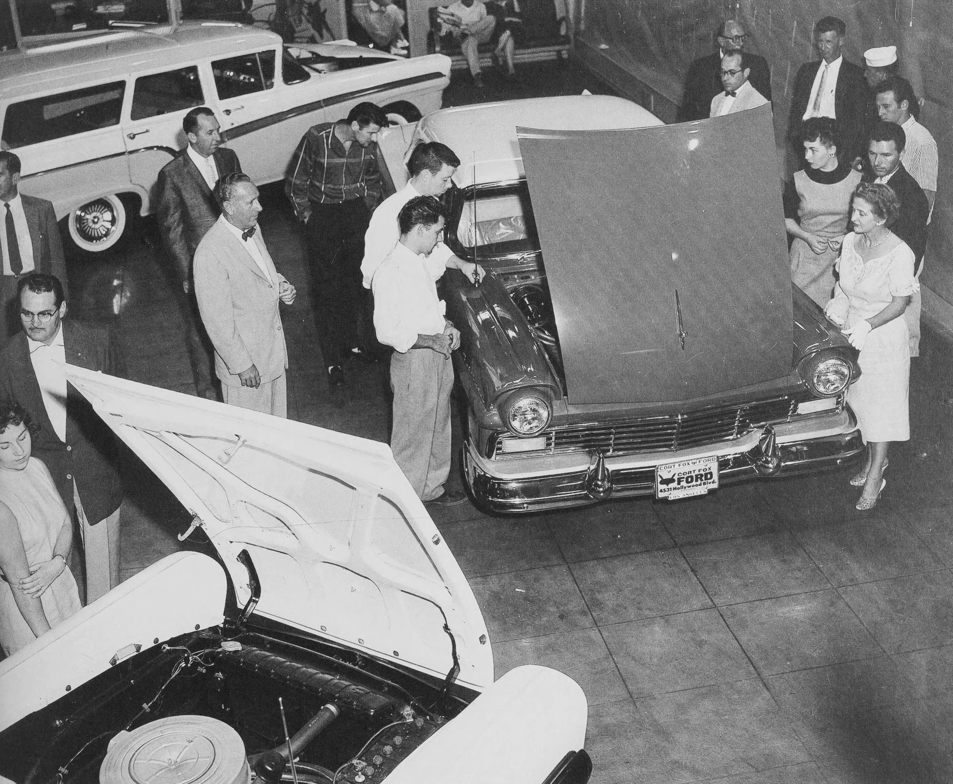 The 1957–1959 Ford-Chevrolet Sales Race: Busting Some Myths About When Ford Finally Beat Chevrolet — Twice 13 B&W photo of people looking at several 1957 Ford cars in a dealer showroom