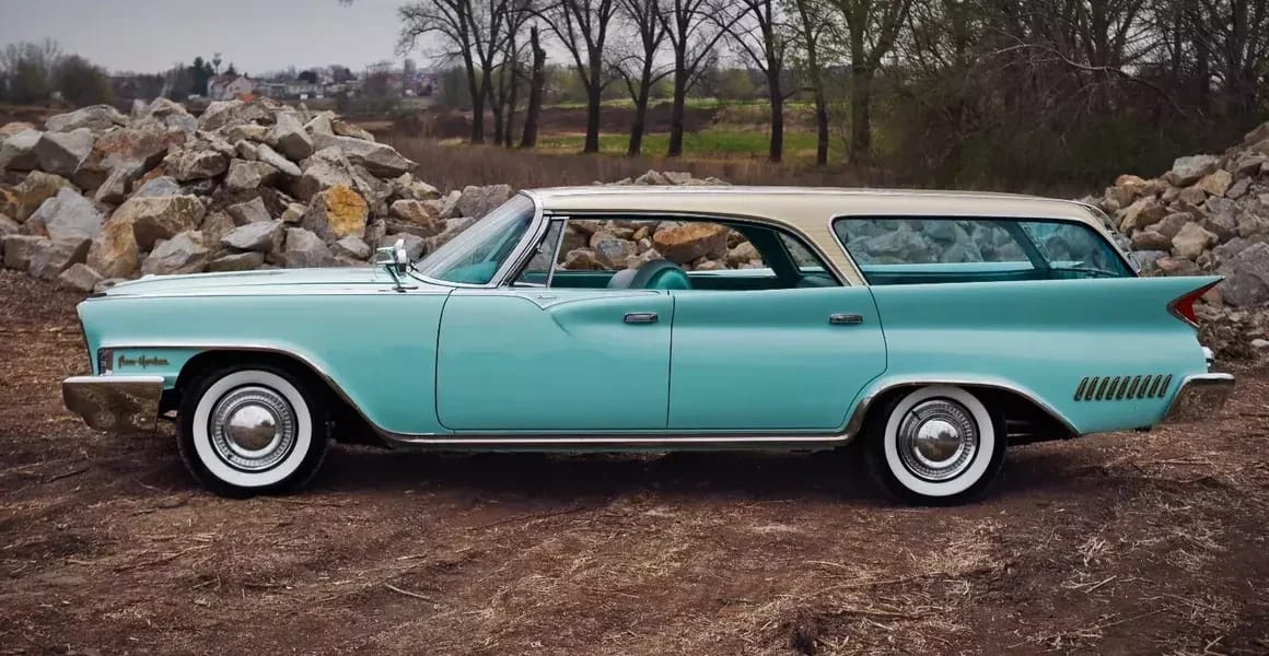 1962 Chrysler New Yorker Town & Country: 1962's Most Expensive Luxury Wagon Was A 1961 Plymouth In Disguise 4 Left side view of a two-tone 1961 Chrysler four-door hardtop wagon with prominent tail fins