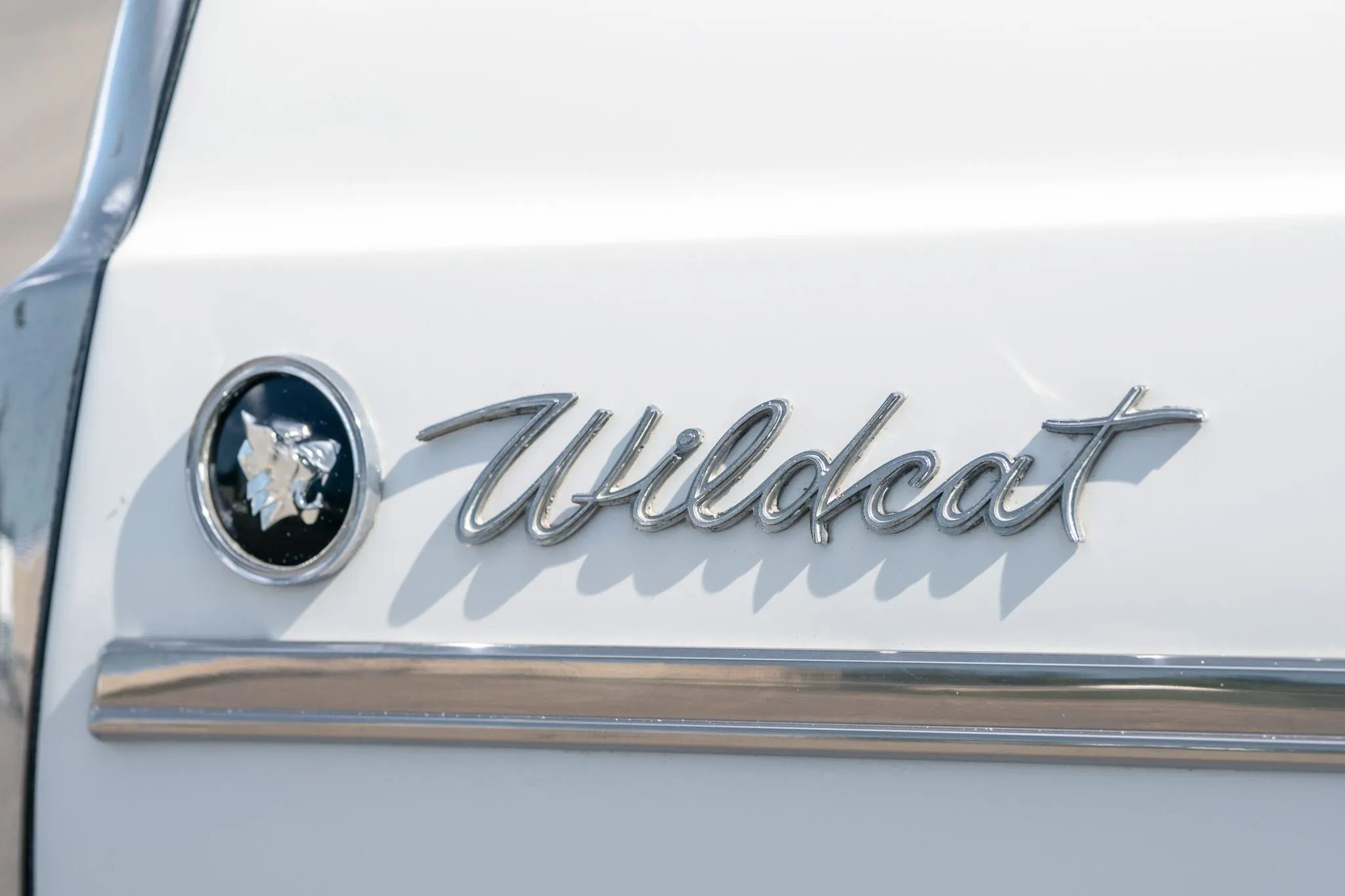 Closeup of the Wildcat badges on the rear fender of a 1963 Buick