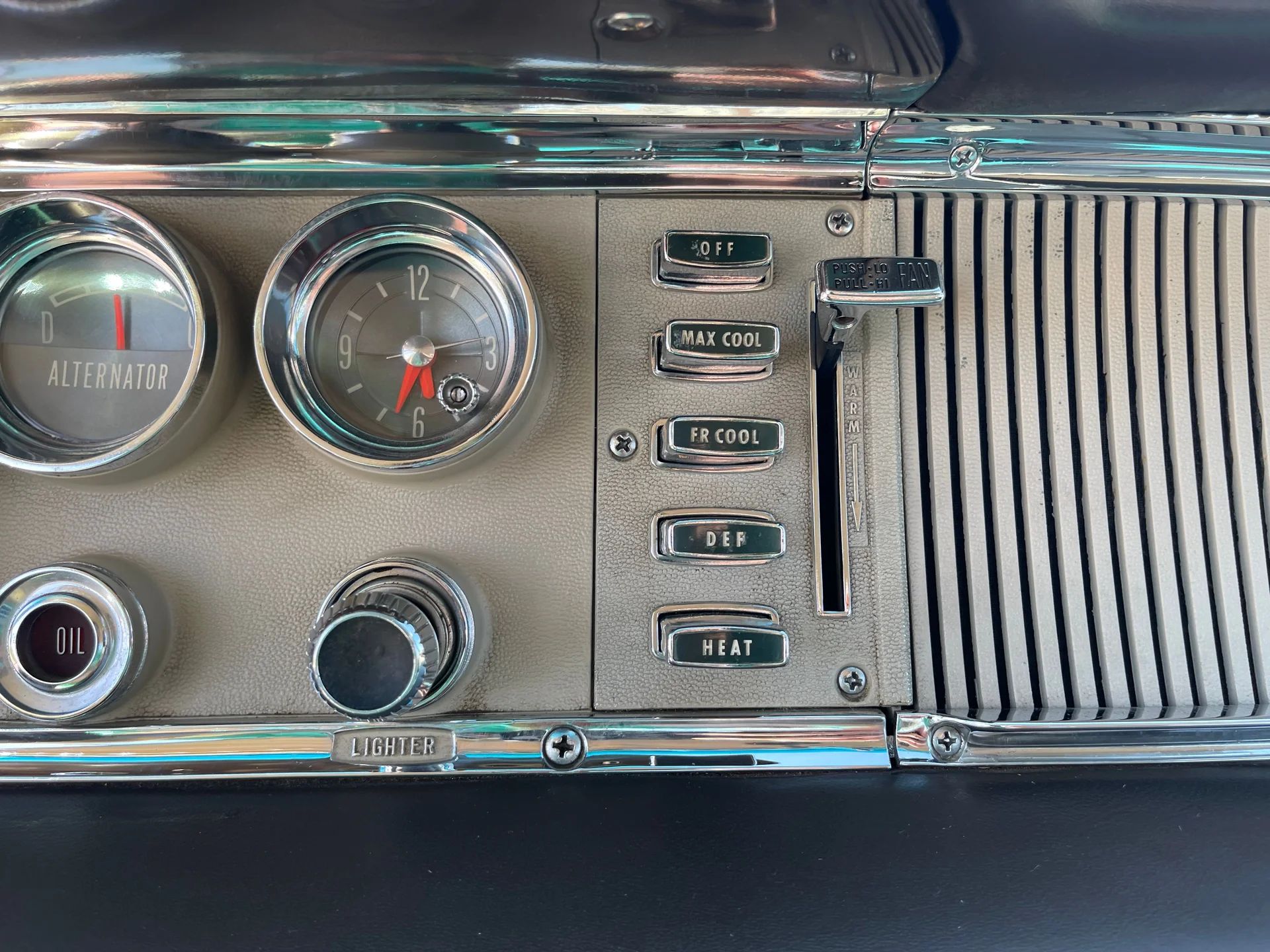 HVAC controls and clock on the dash of a 1964 Chrysler