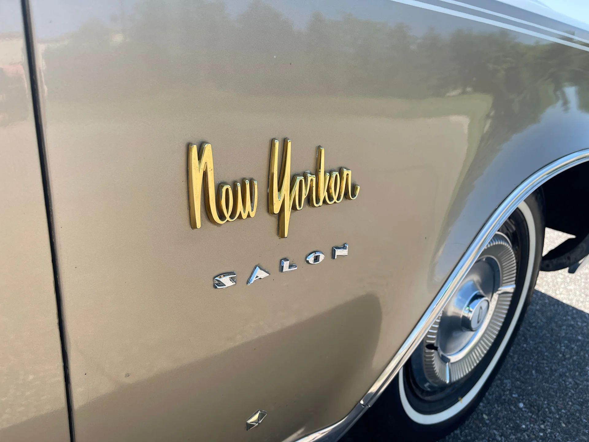 "New Yorker Salon" badges on the right front fender of a 1964 Chrysler