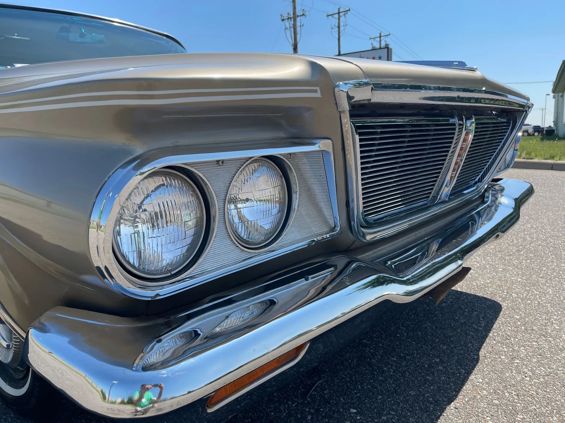 Closeup of the headlights and grille of a 1964 Chrysler