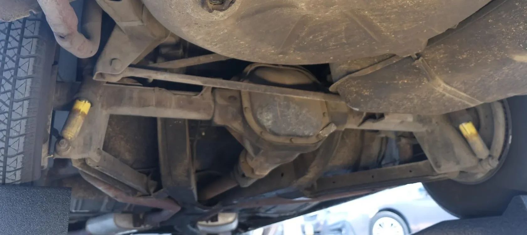 Vintage Car Life Review: 1969 Buick Riviera With Accu-Drive – Buick Tries Something New In The Suspension Department 11 Fuel tank and rear axle of a 1969 Buick Riviera, seen from underneath with the car on a hoist