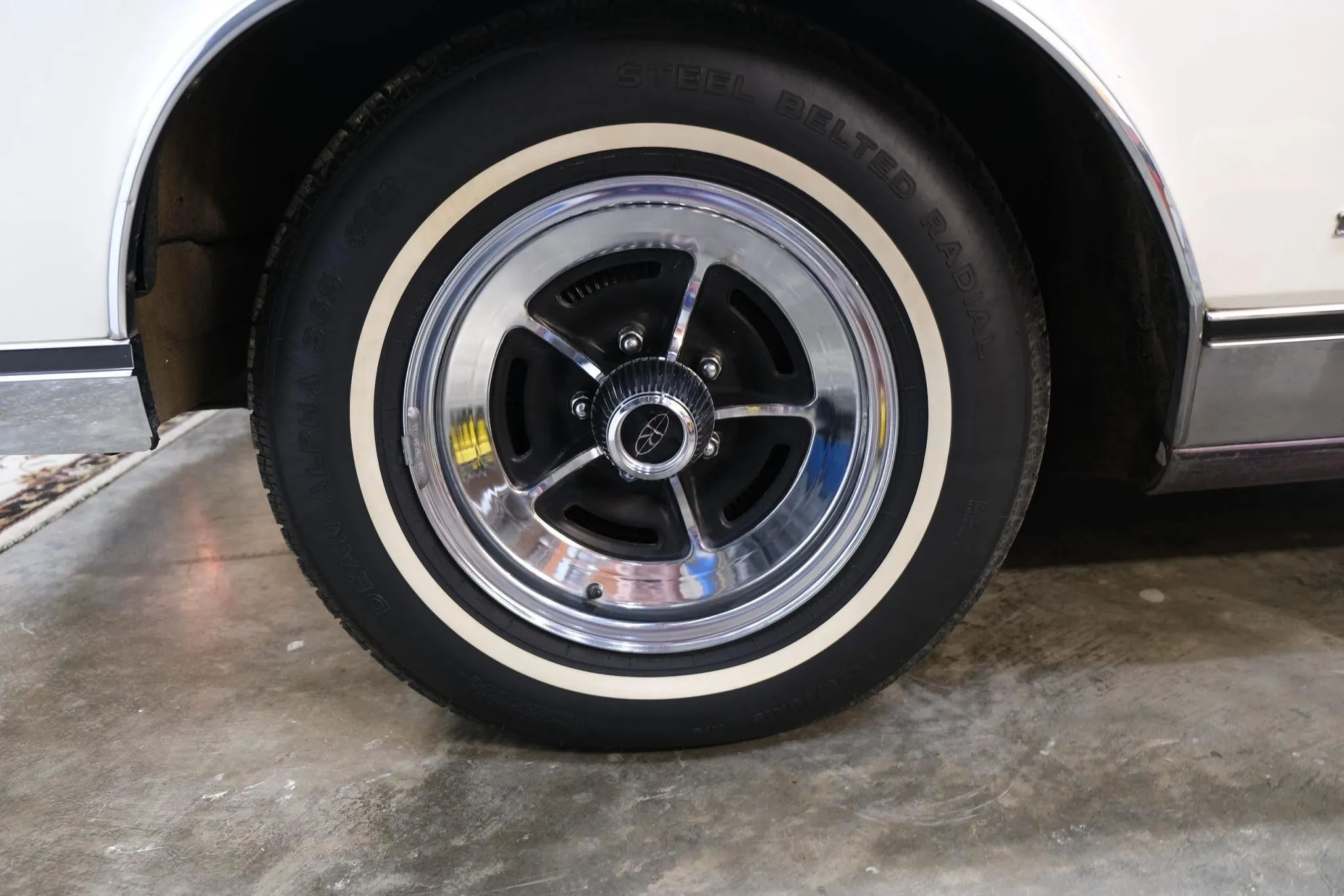Vintage Car Life Review: 1969 Buick Riviera With Accu-Drive – Buick Tries Something New In The Suspension Department 14 Wheel and whitewall tire on a white car