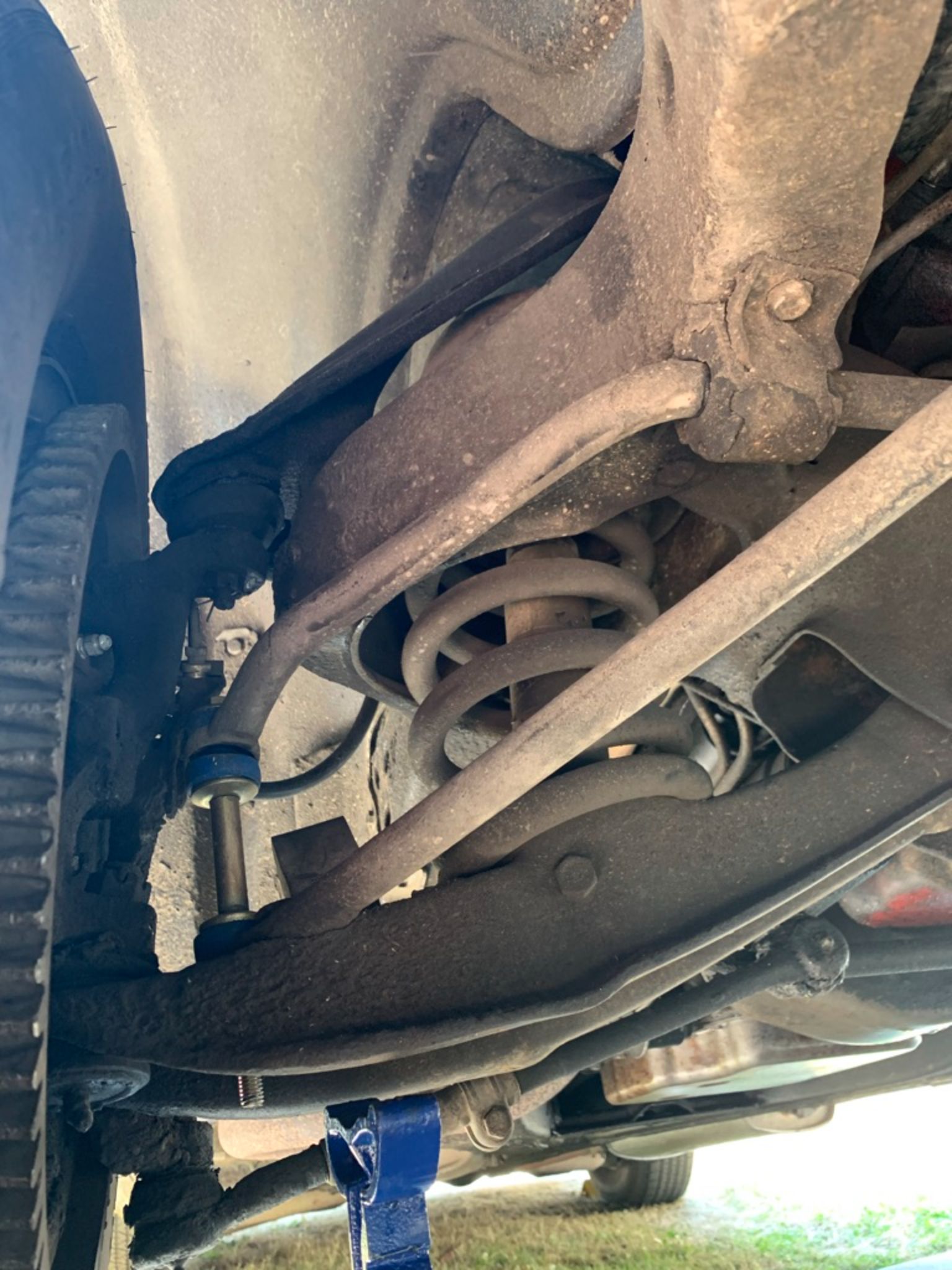 Vintage Car Life Review: 1969 Buick Riviera With Accu-Drive – Buick Tries Something New In The Suspension Department 9 Front suspension arms of a 1969 Buick, seen from the front with the car up on a hoist