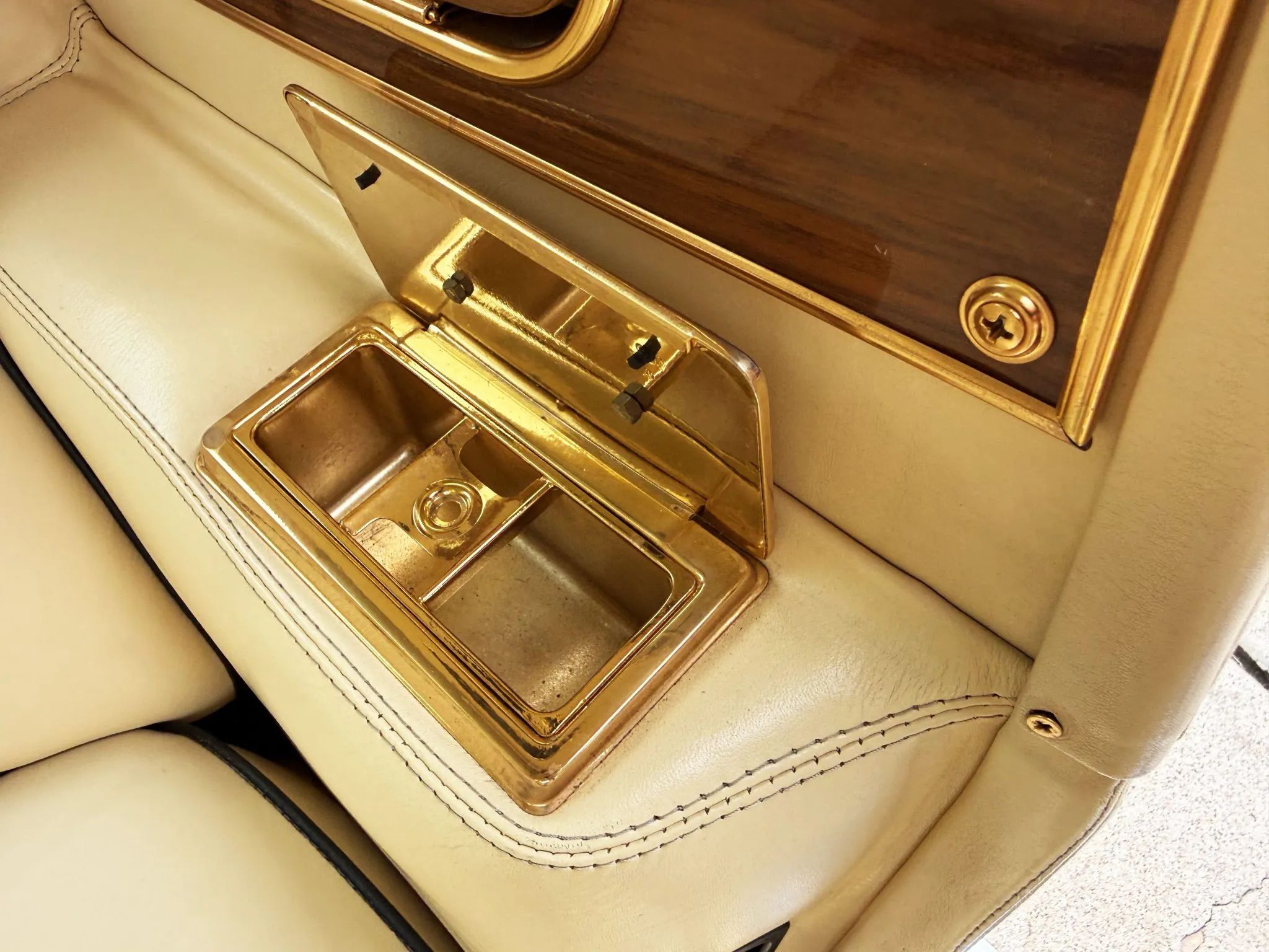 Closeup of a gold armrest ashtray
