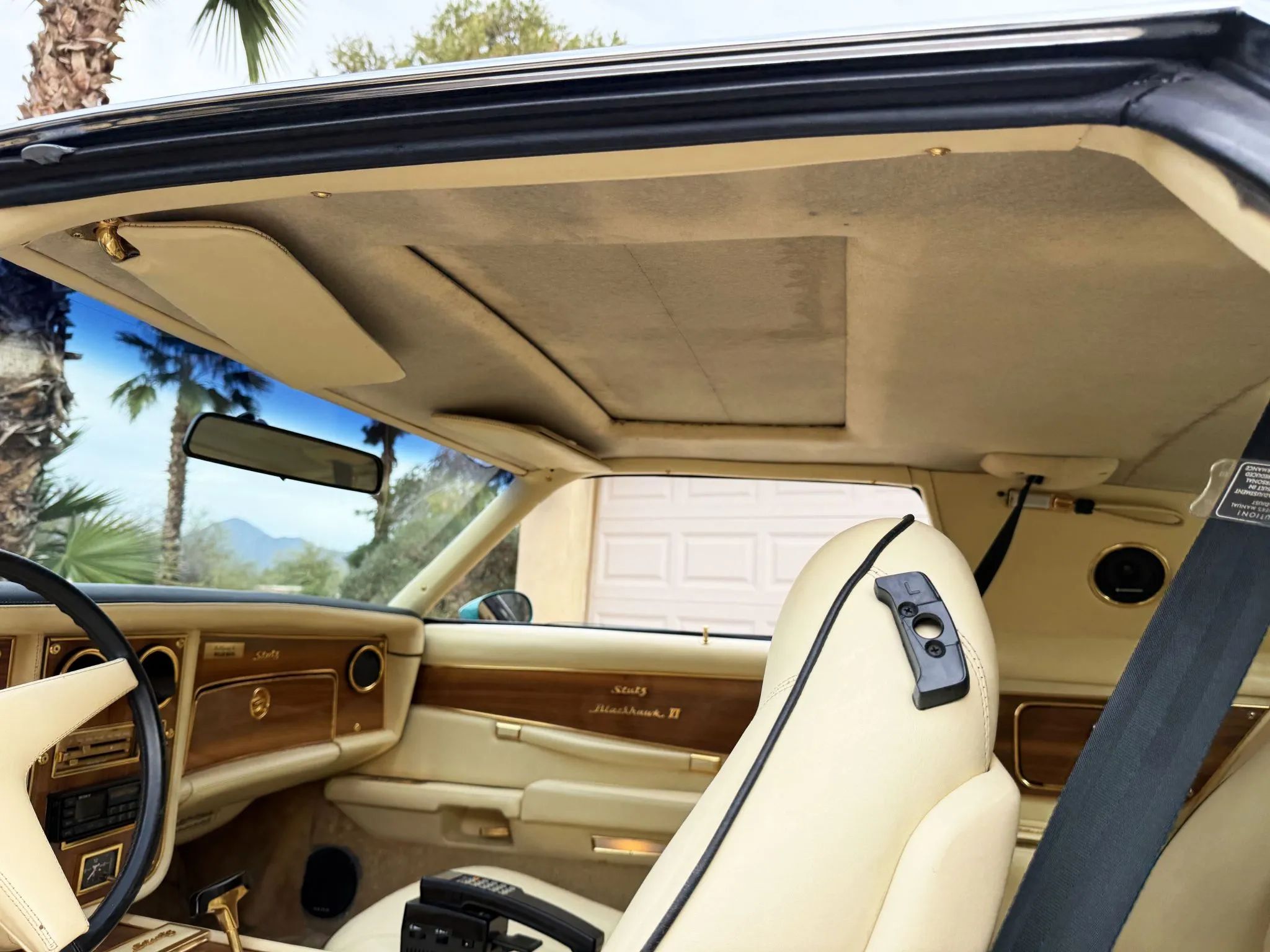 Roof of a 1978 Stutz, showing the closed sunroof in the headliner, which is surrounded with dark stains