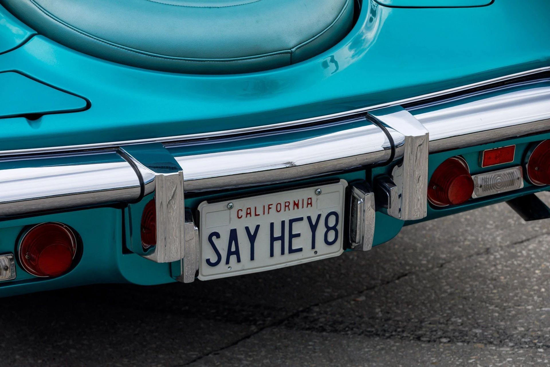 California license plate "SAY HEY1" on the rear of a turquoise Stutz