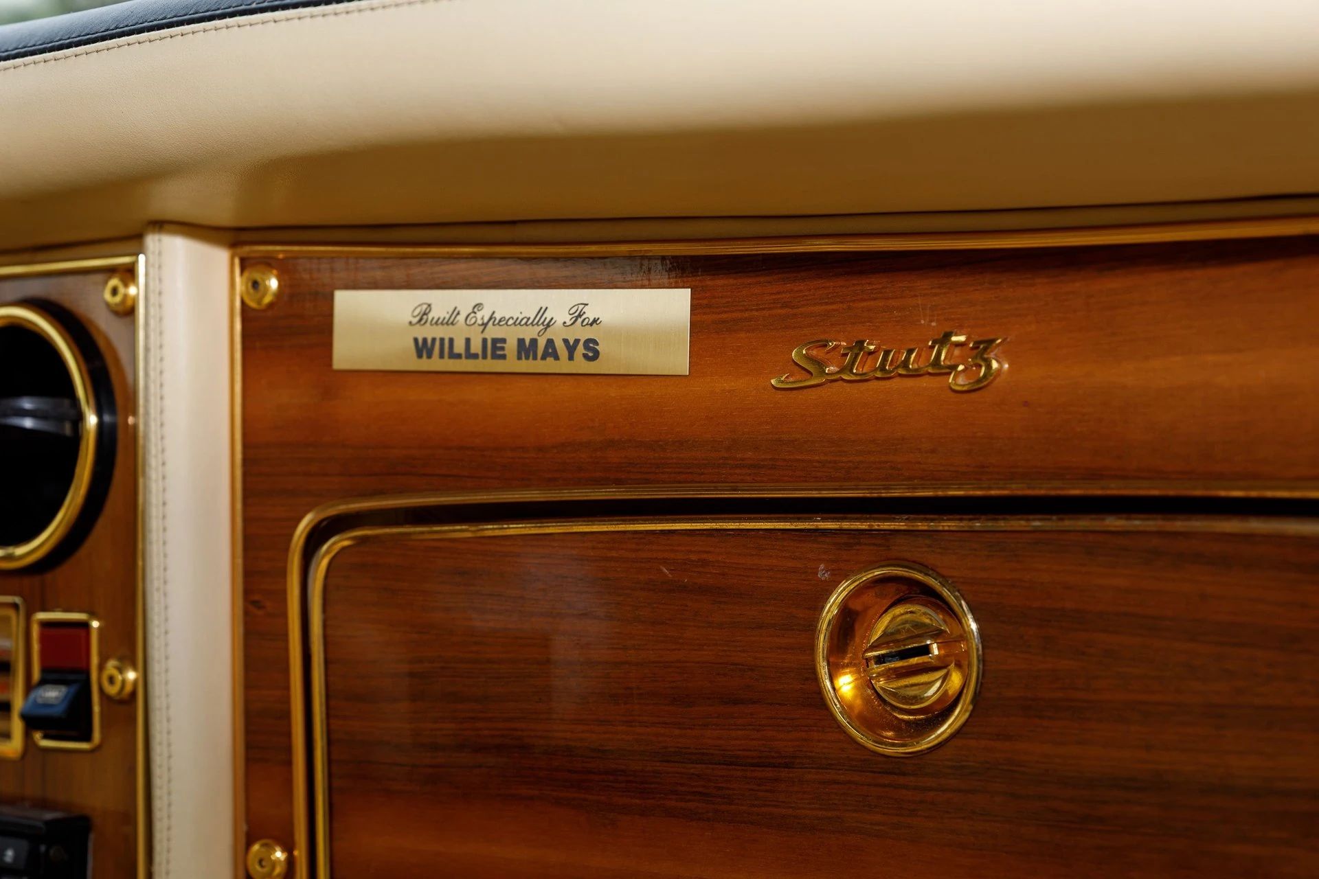 Glove box surround of a 1978 Stutz, with a gold plate above the glove box lid