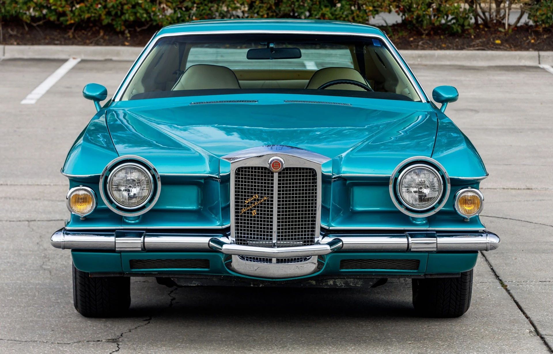 Front view of a turquoise 1978 Stutz with a stand-up grille and free-standing headlights