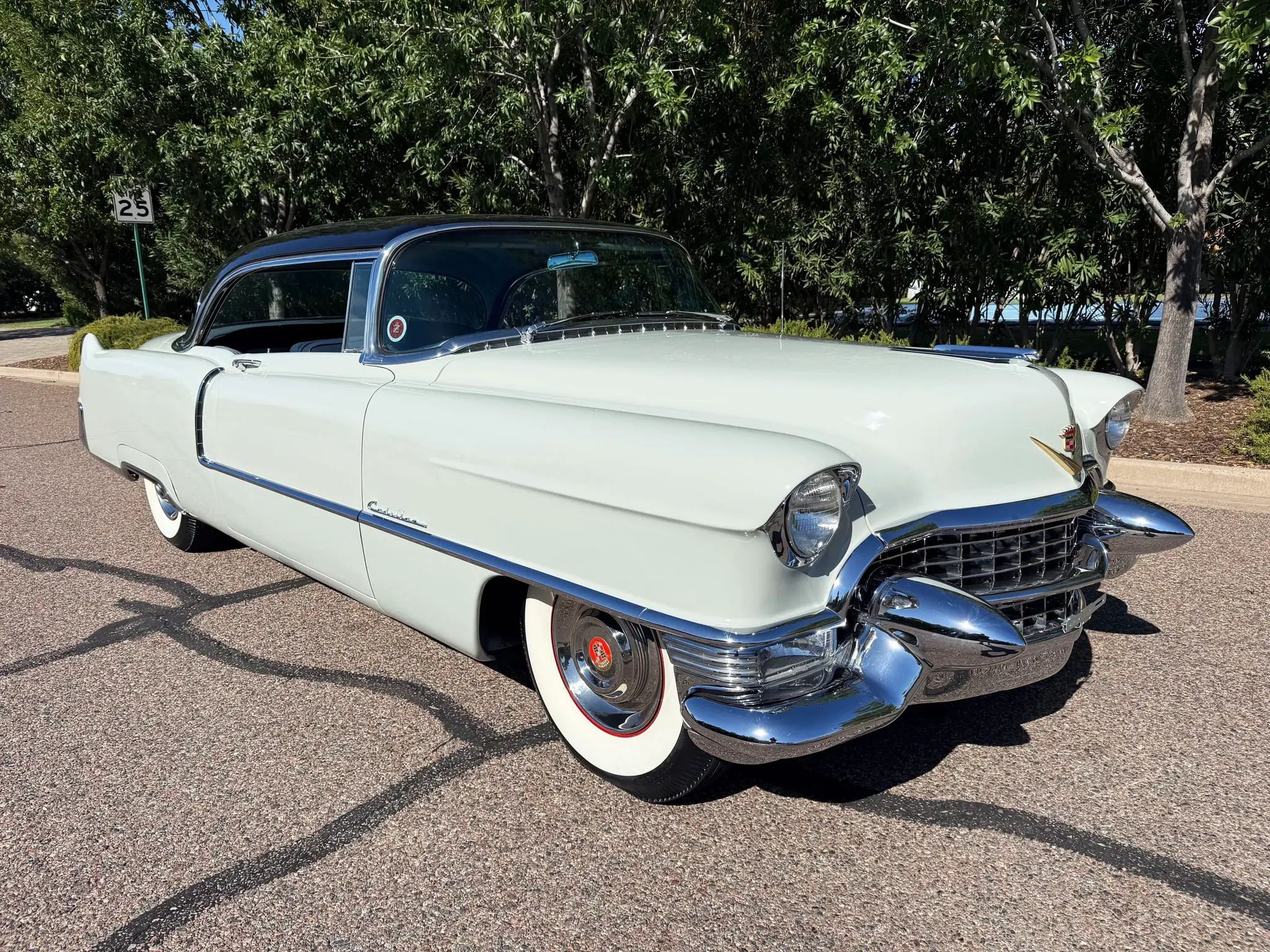 Passenger front 3q picture of gray 1955 Cadillac Series 62 Coupe