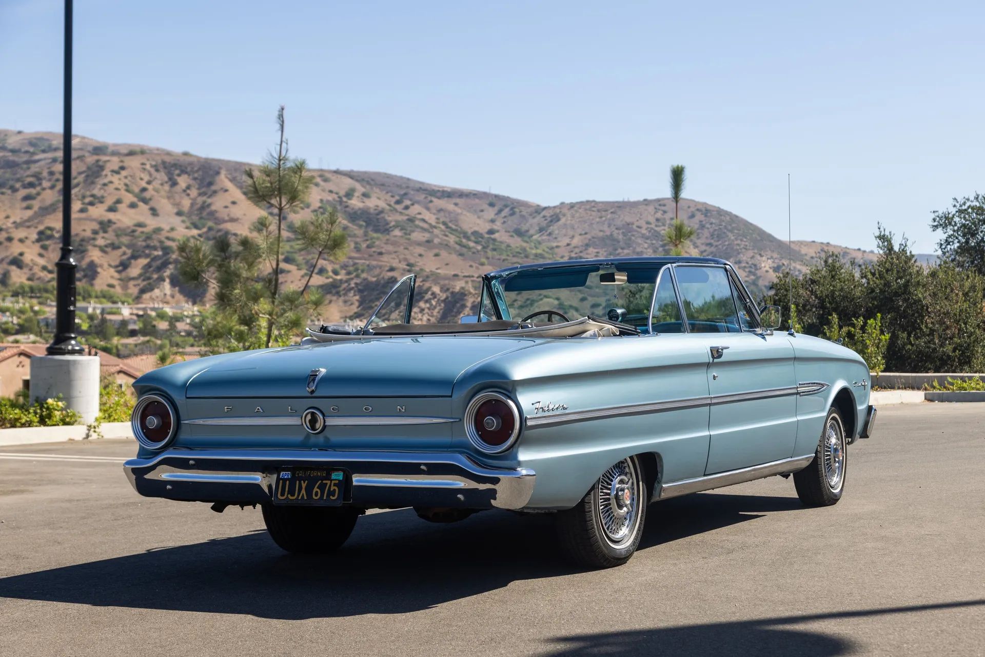1963 Ford Falcon Sprint Convertible: A Soft Open For The Mustang 8 Passenger rear 3q picture of blue 1963 Ford Falcon Sprint Convertible in desert parking lot