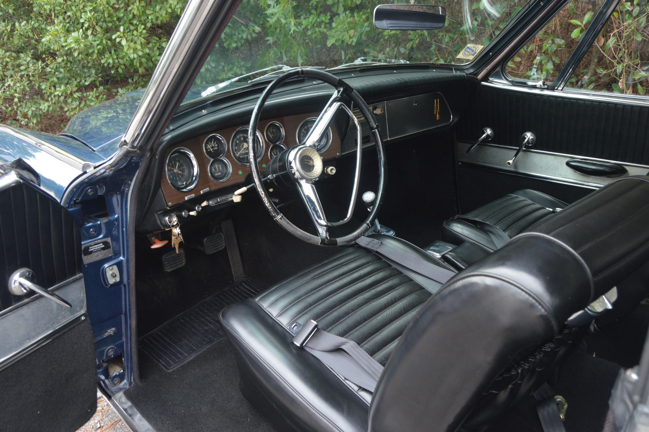 Black interior of dark blue 1963 Studebaker GT Hawk with four-speed manual transmission