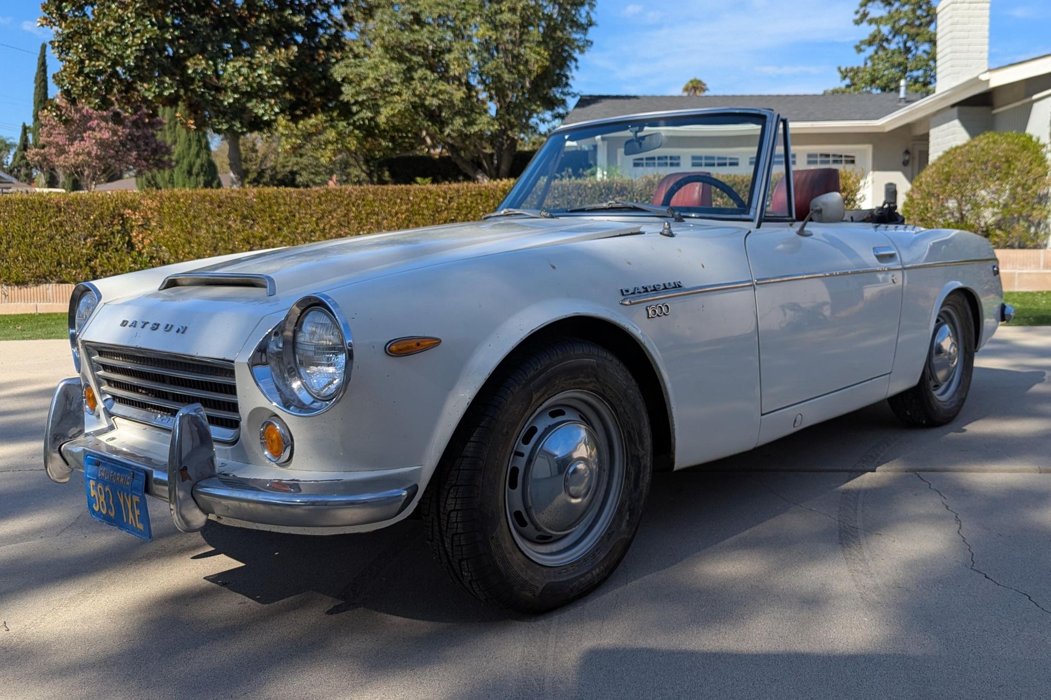 1969 Datsun 1600 Roadster: A Fun Winter Project With A Pile Of Spare Parts 1 Driver front 3q picture of a white 1969 Datsun 1600 Roadster in a residential driveway