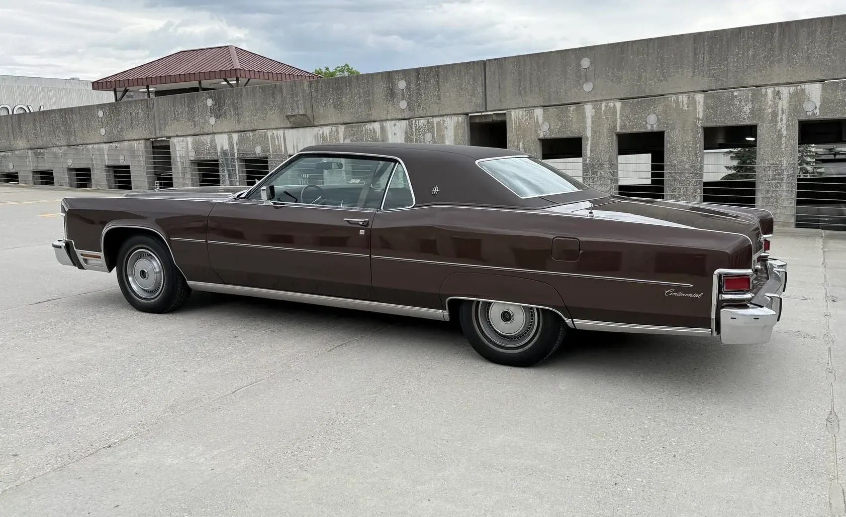 1974 Lincoln Continental Coupe: At Under $2,000, It Was The Steal Of The Week 11 Driver side profile of brown 1974 Lincoln Continental Coupe on a parking garage roof