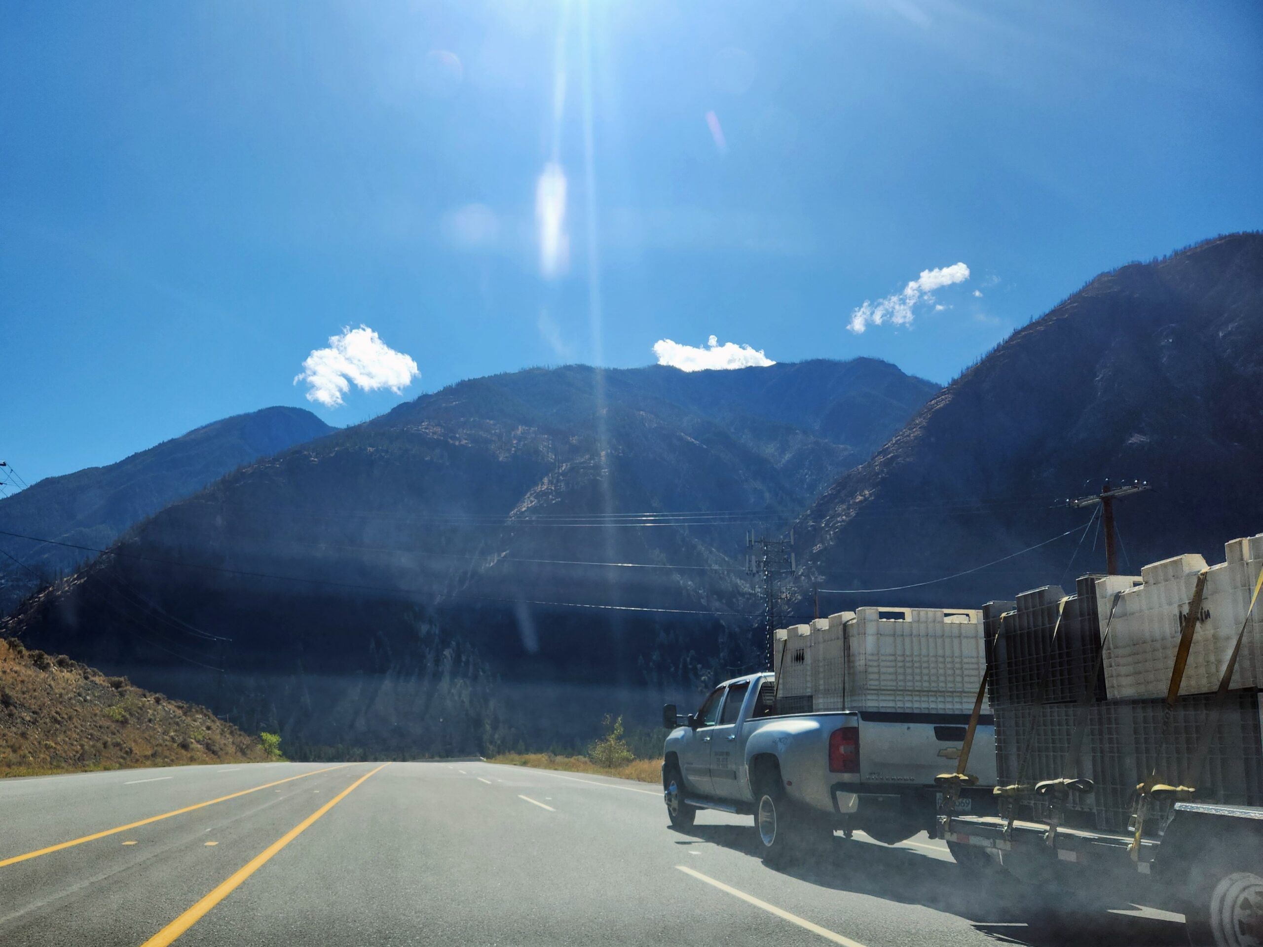 A truck on the highway with trailer.