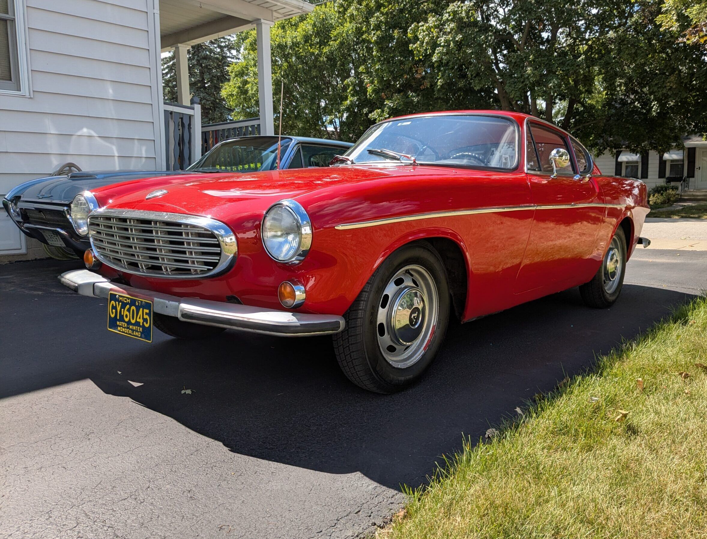 My 1967 Volvo 1800S: A Year After Its Purchase, I No Longer Completely Regret It 1 Driver fron 3q picture of red 1967 Volvo 1800S in a residential driveway