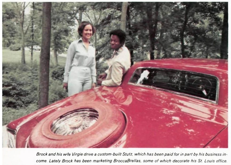 Lou Brock and his wife Virgie leaning on a red Stutz, with the headline "Brock and his wife Virgie drive a custom-built Stutz, which has been paid for in part by his business income. Lately Brock has been marketing BroccaBrellas, some of which decorate his St. Louis office"
