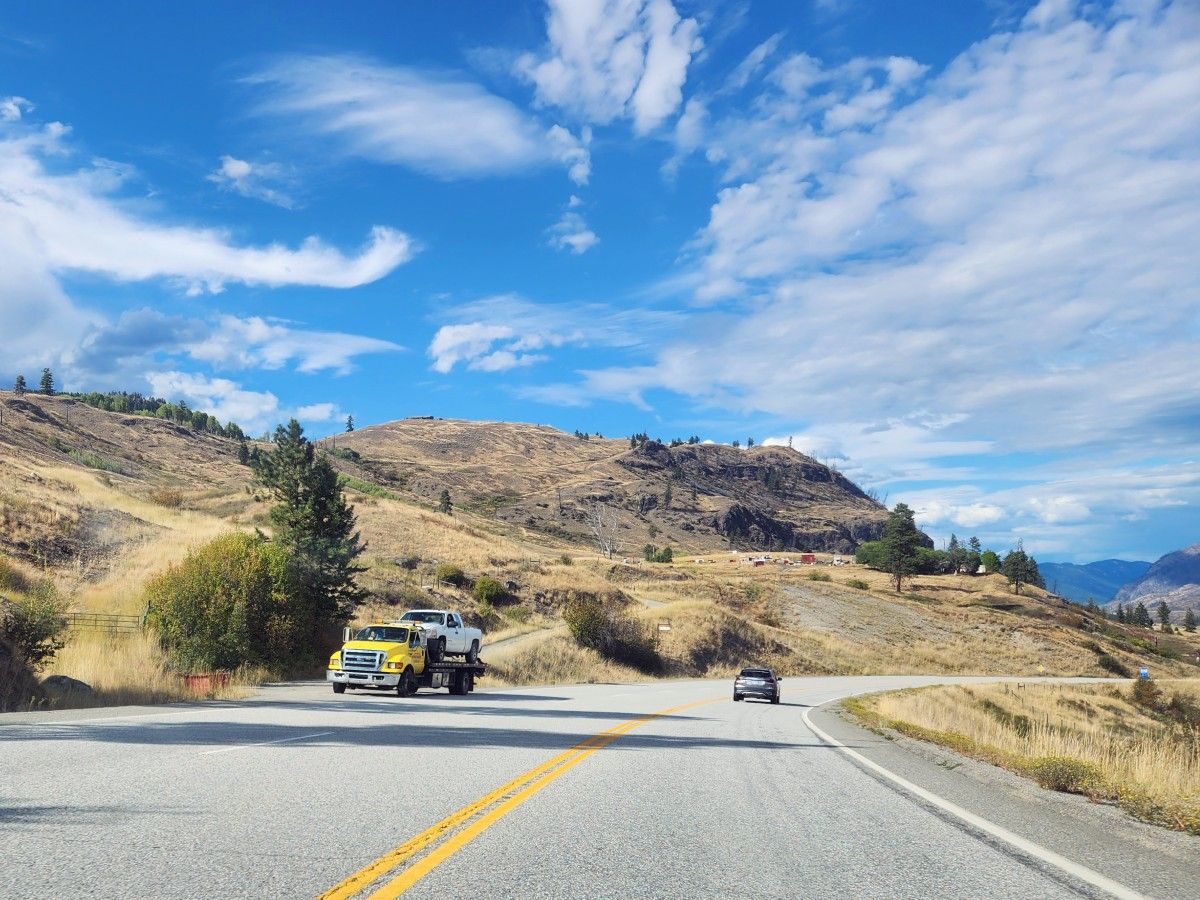 A tow truck on a mountain road.