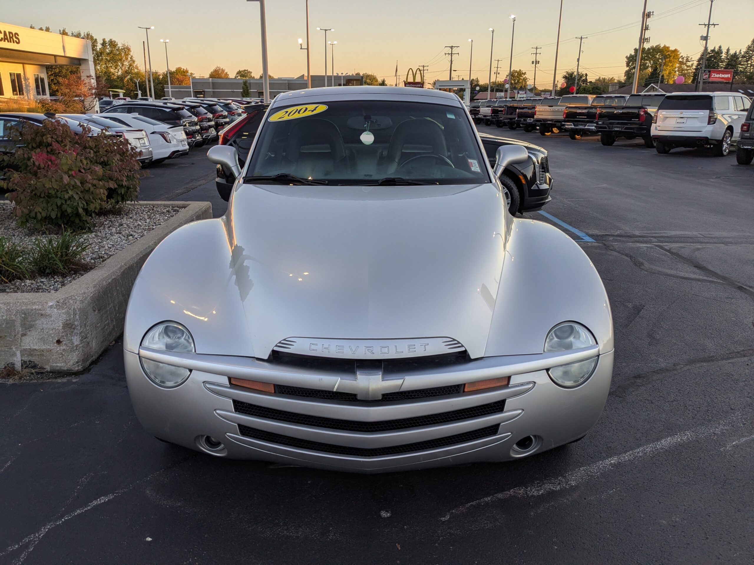 2004 Chevrolet SSR: A Convertible Two-Seater Truck? A Retro Curiosity Worth A Second Look 2 Front of silver 2004 Chevrolet SSR parked in dealer parking lot at dusk