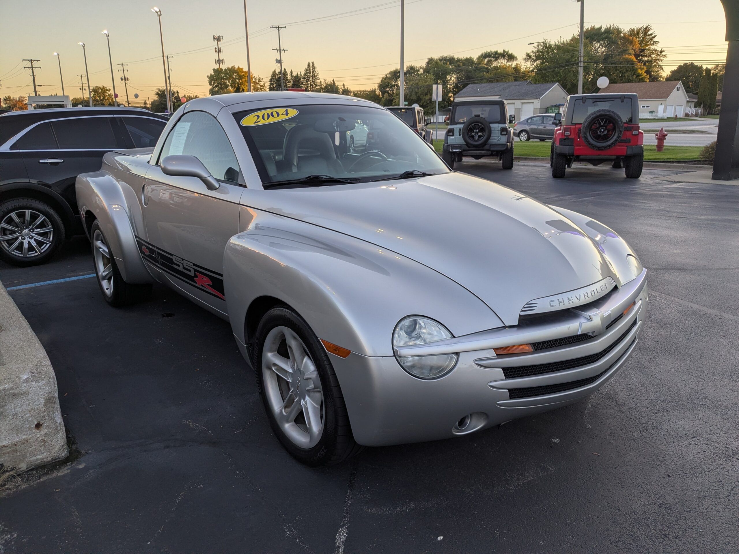 2004 Chevrolet SSR: A Convertible Two-Seater Truck? A Retro Curiosity Worth A Second Look 5 Passenger front 3q picture of silver 2004 Chevrolet SSR in dealer parking lot at dusk