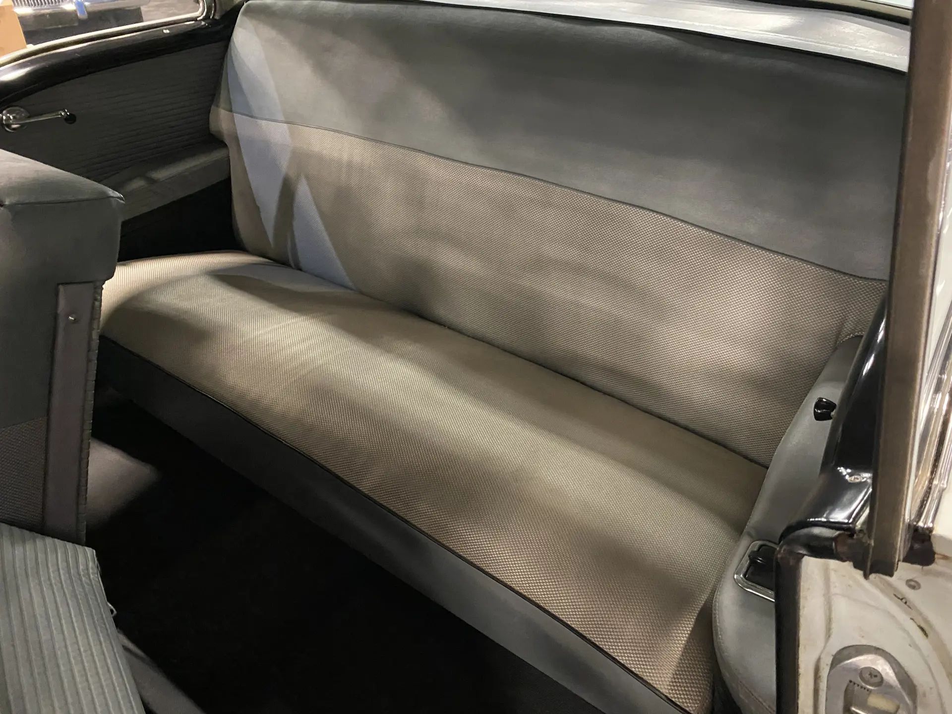 Back seat of a 1955 Buick two-door hardtop, seen through the driver's door