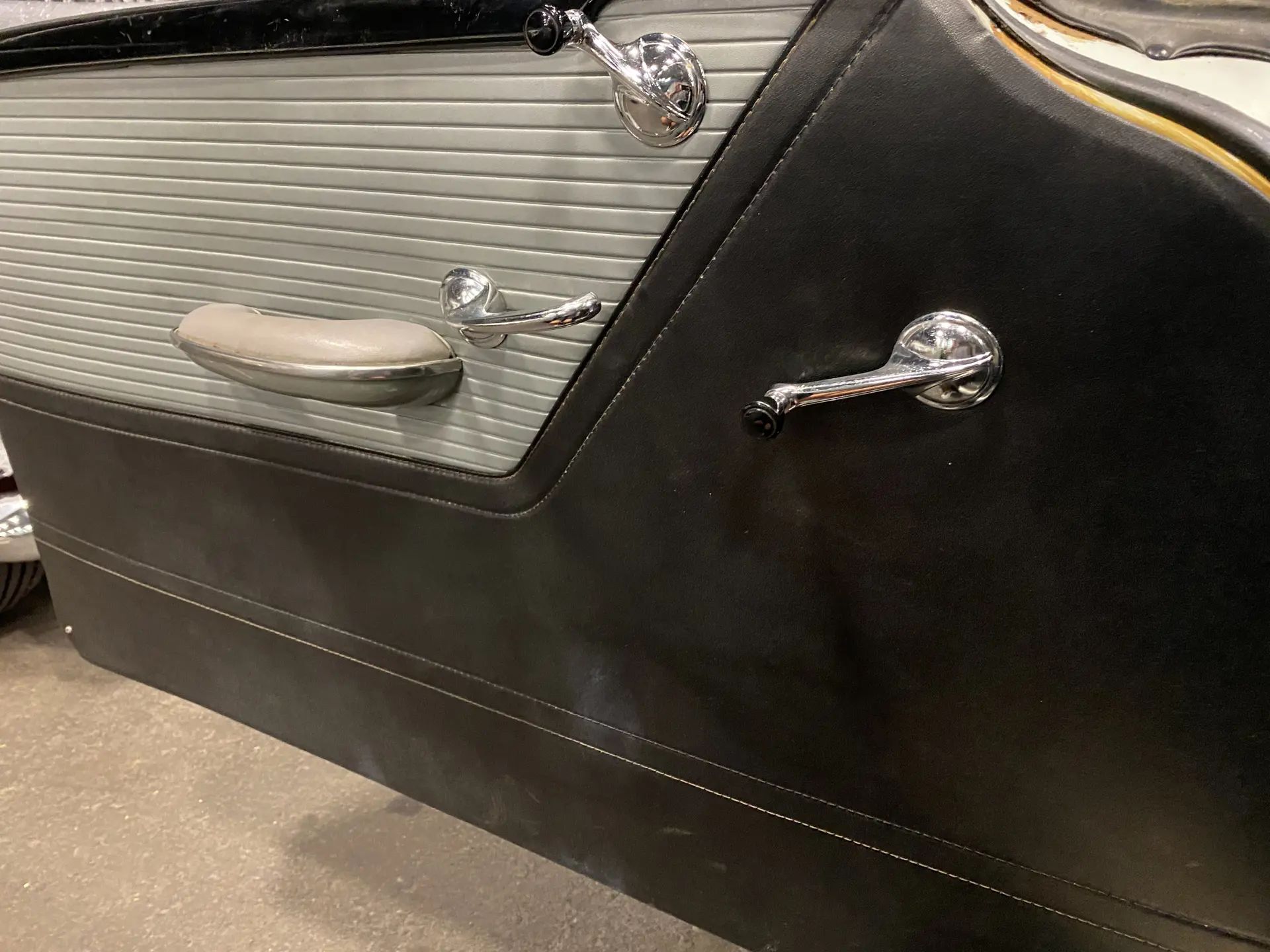 Driver's door trim of a 1955 Buick with wind-up windows