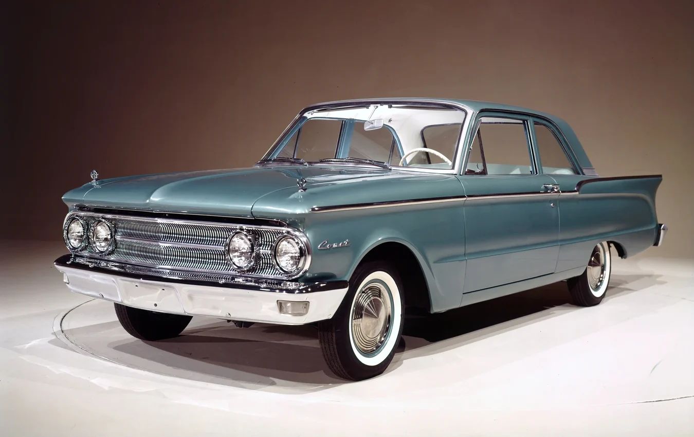 1963 Mercury Comet V-8 Sedan: "For Better Or For Worse, Something Different Under The Hood" 2 Studio shot showing the left front 3q view of a 1960 Comet two-door