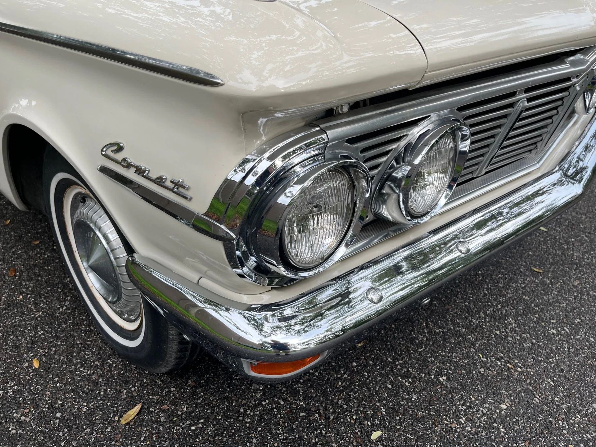 1963 Mercury Comet V-8 Sedan: "For Better Or For Worse, Something Different Under The Hood" 12 Right headlights and front fender Comet badge on a white car